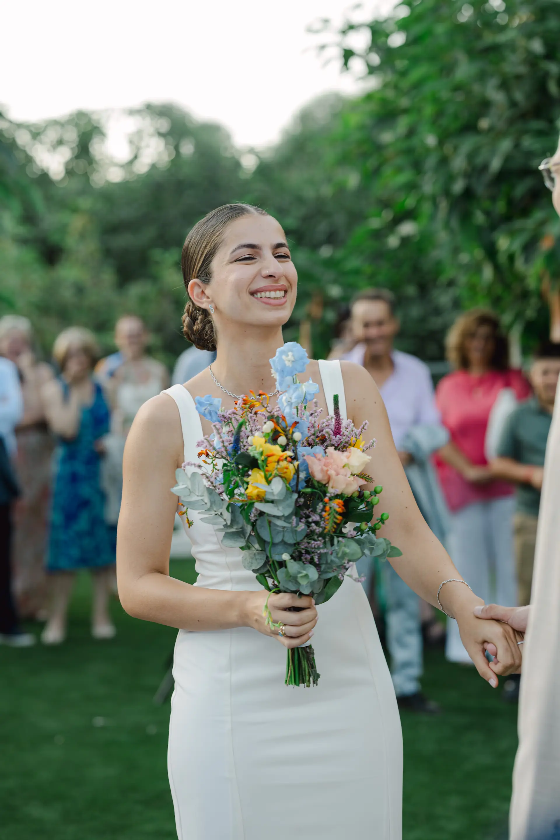 A close-up shot of a bride holding a beautiful wedding bouquet of flowers.