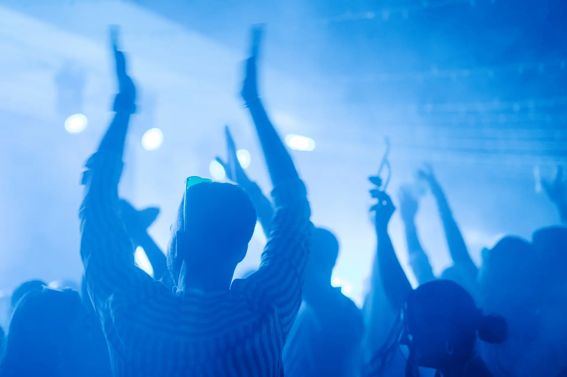 a group of people with their arms raised in the air