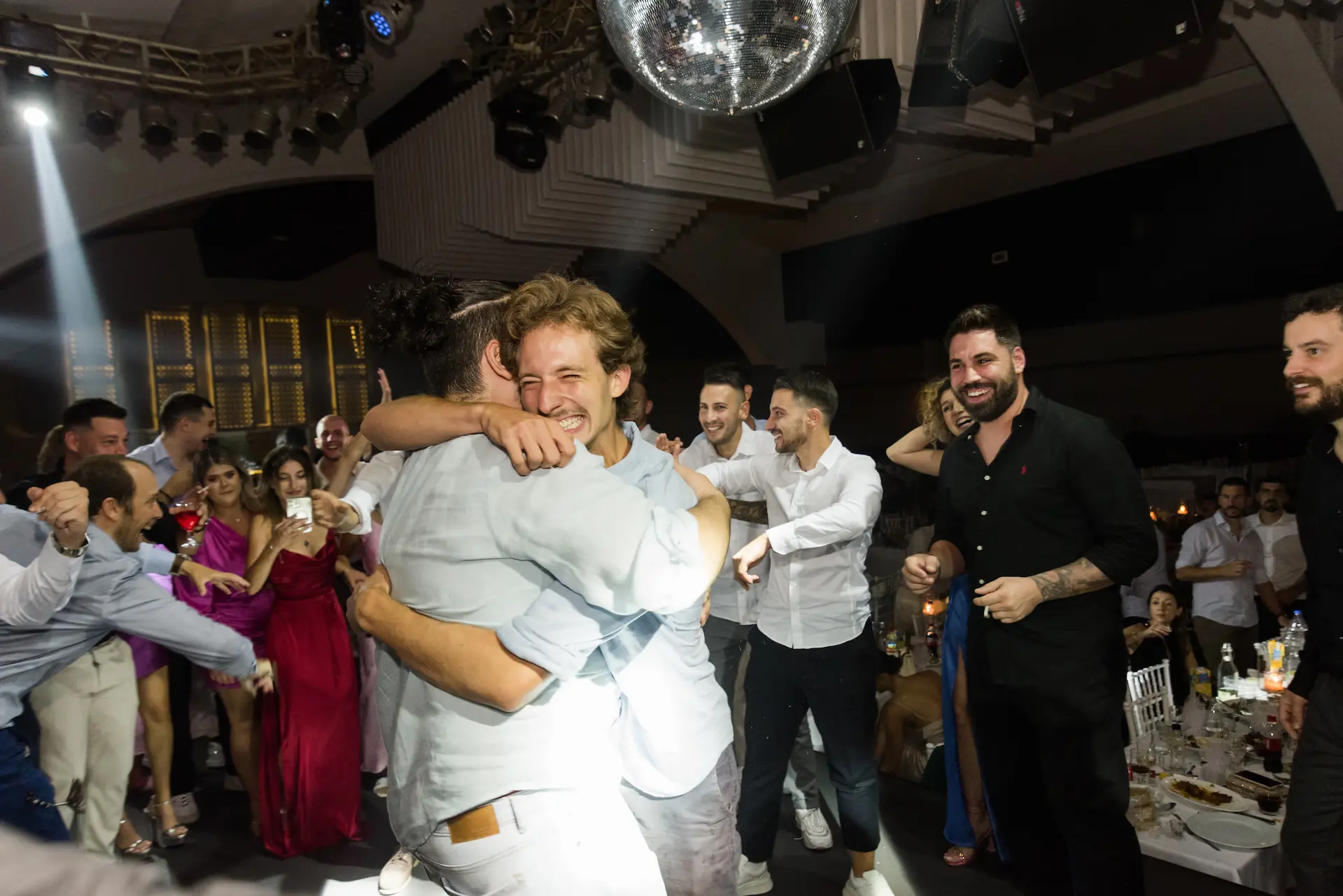 a group of people hugging during wedding party