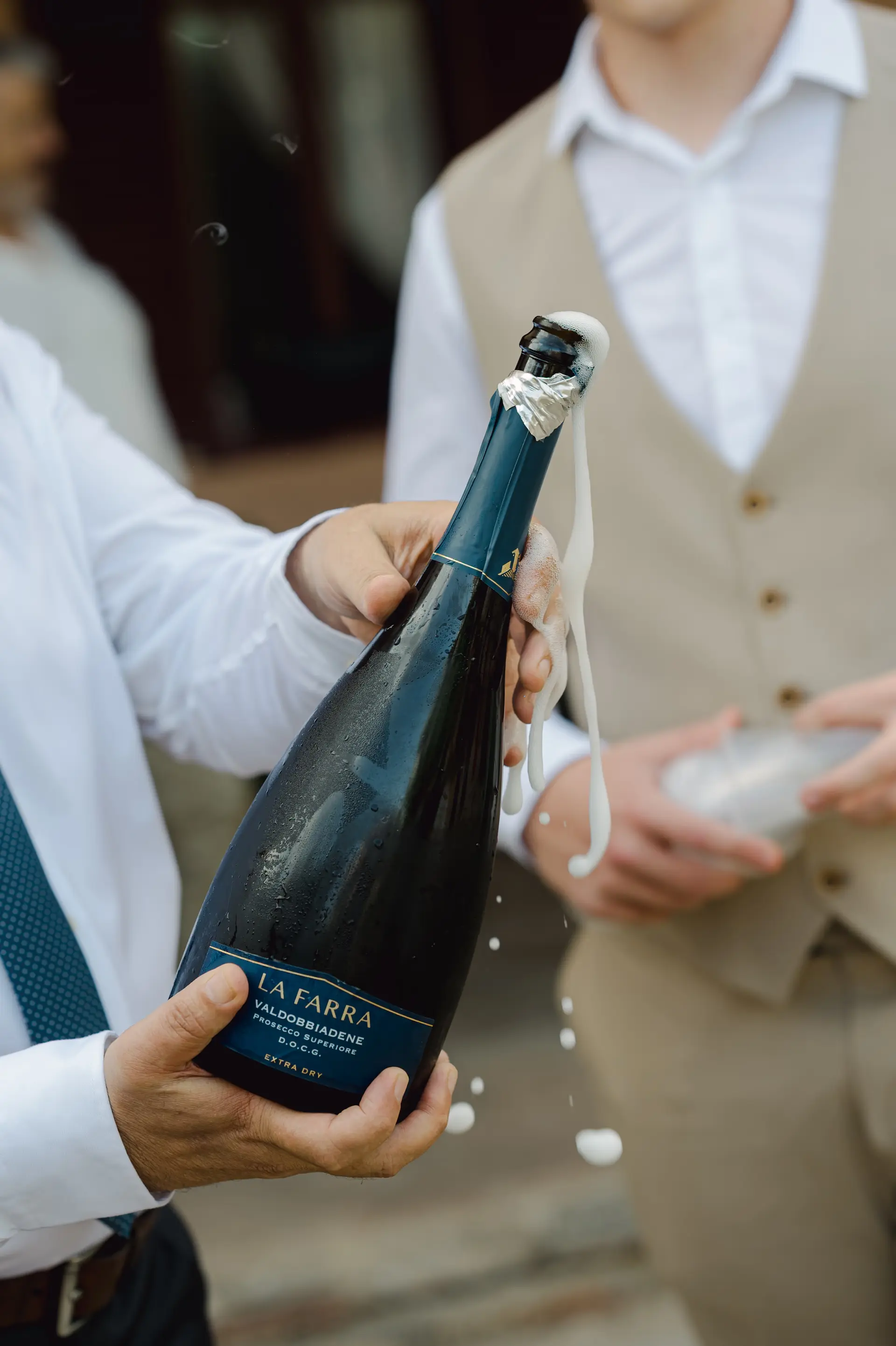 bride's father holding a bottle of champagne