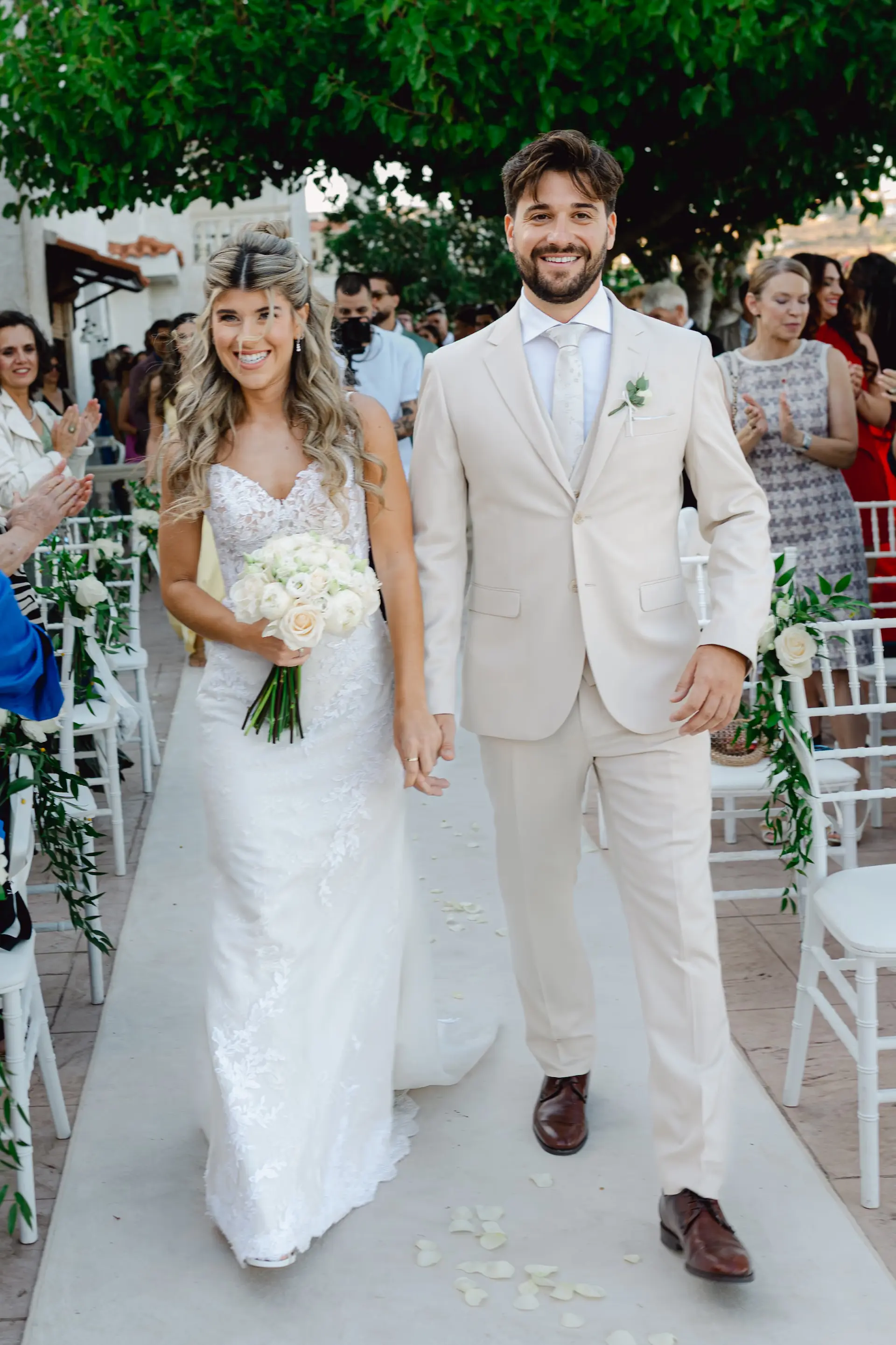 Happy newlyweds walking down the aisle together after their wedding ceremony