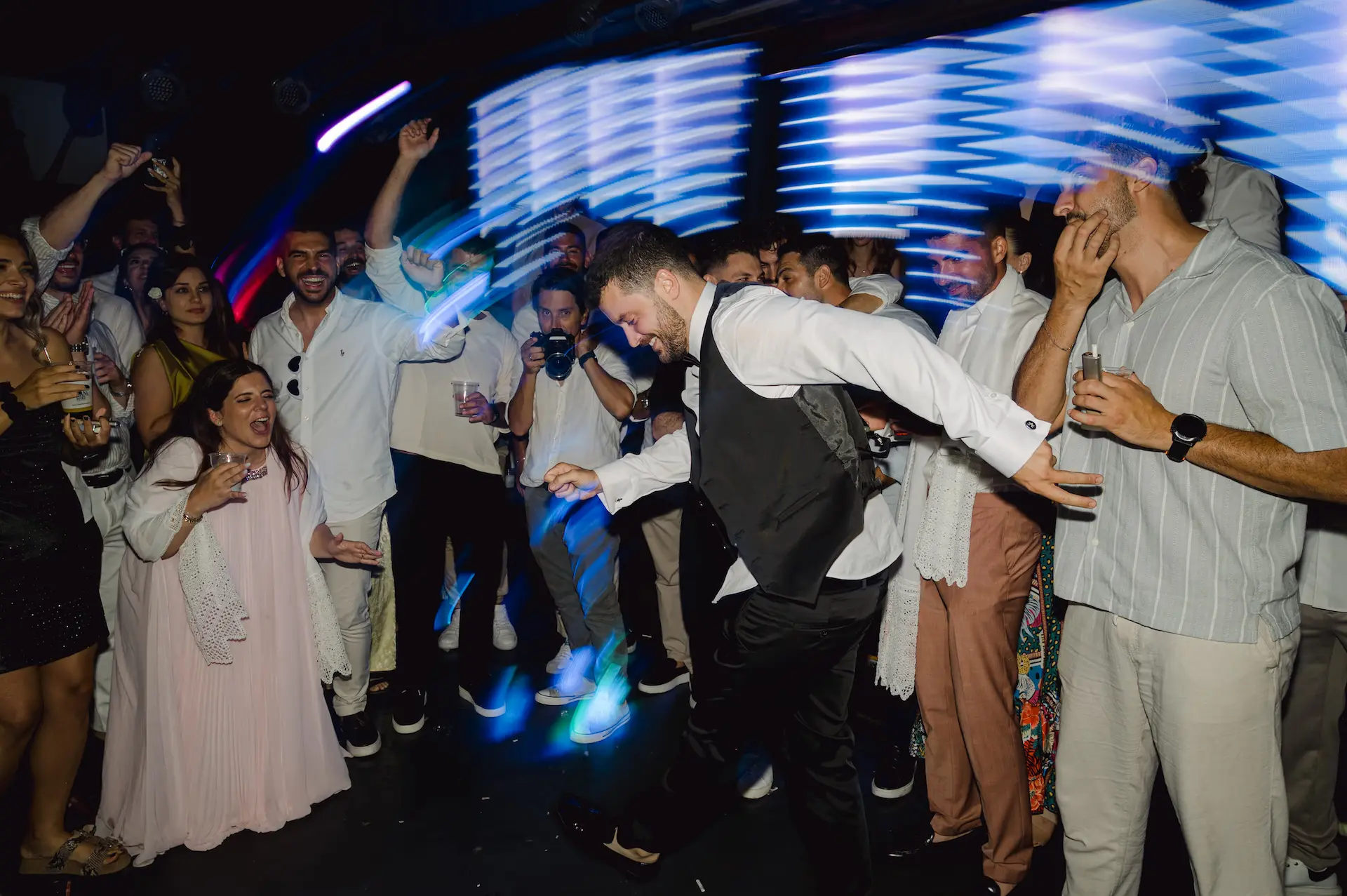 groom dancing break dance in front of his friends