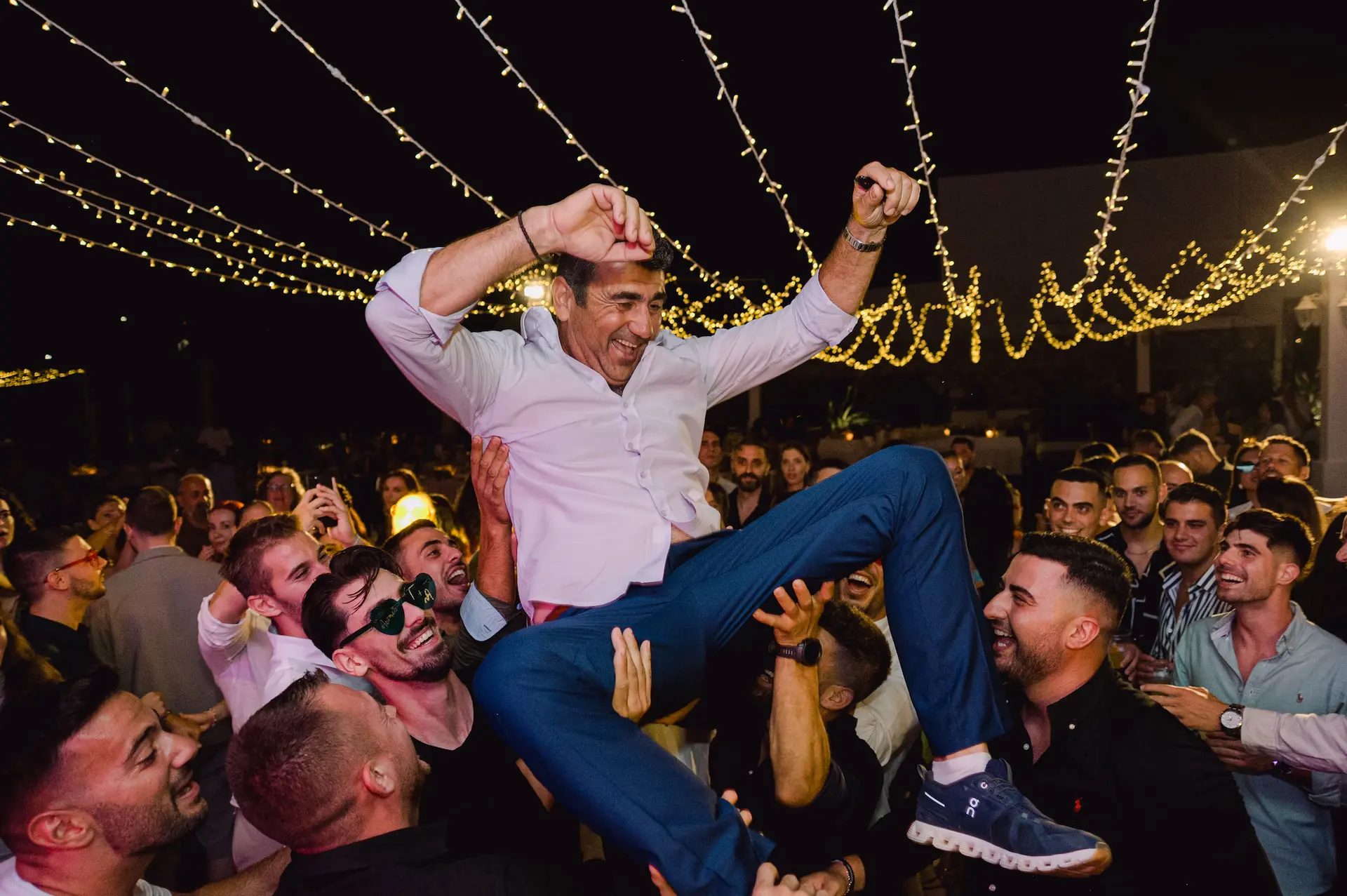 a man in the air with a crowd of people