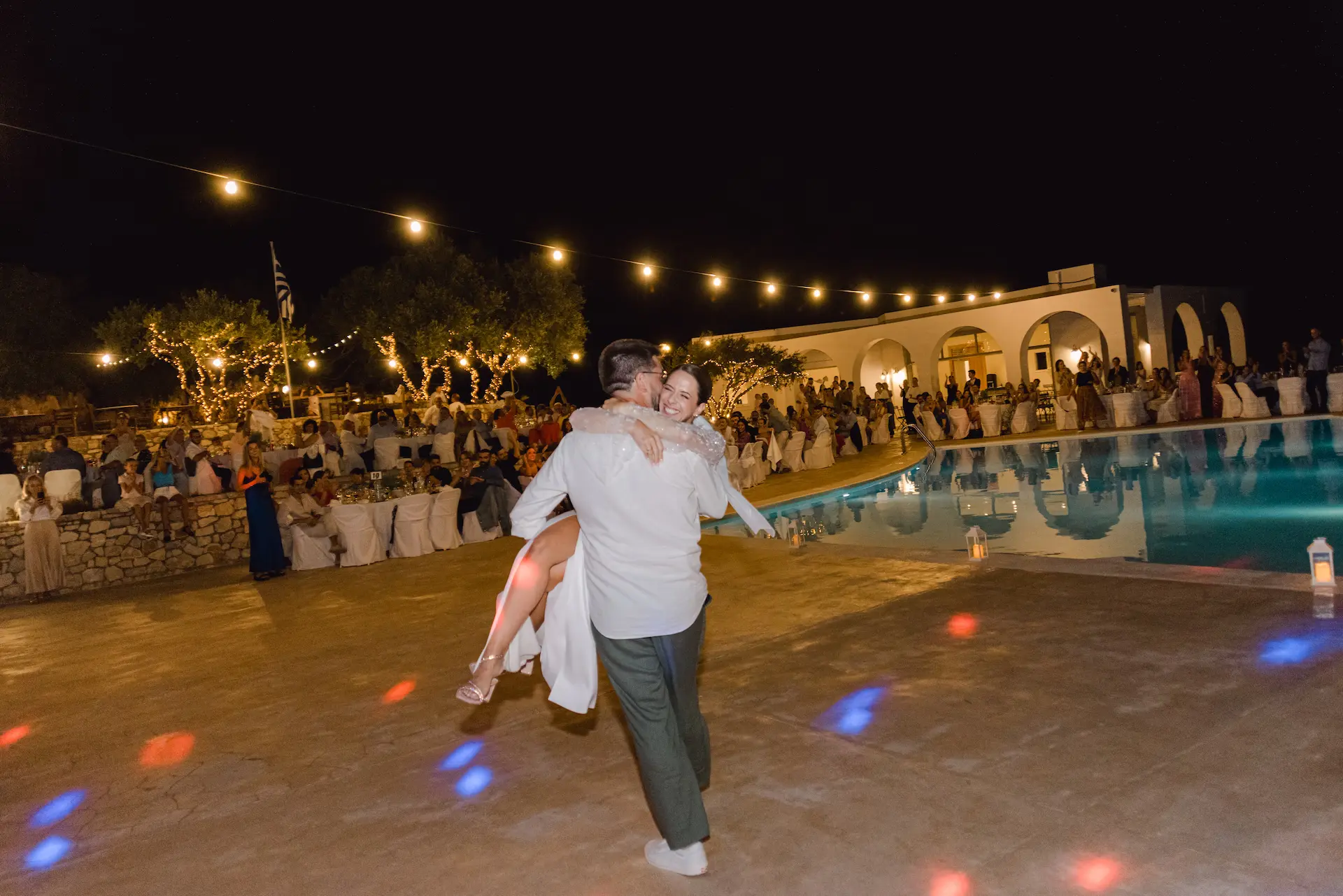 groom lifts bride in a romantic and happy moment