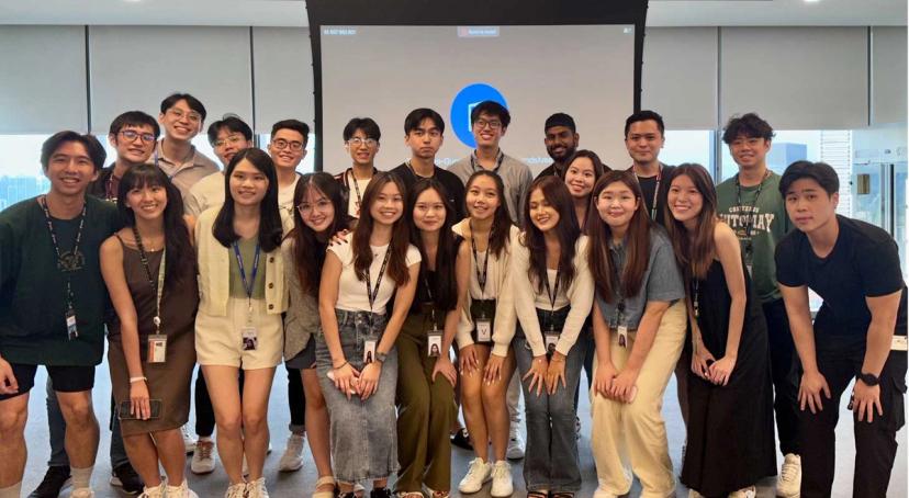 A group of graduates pose together for a group photo in a TikTok office.