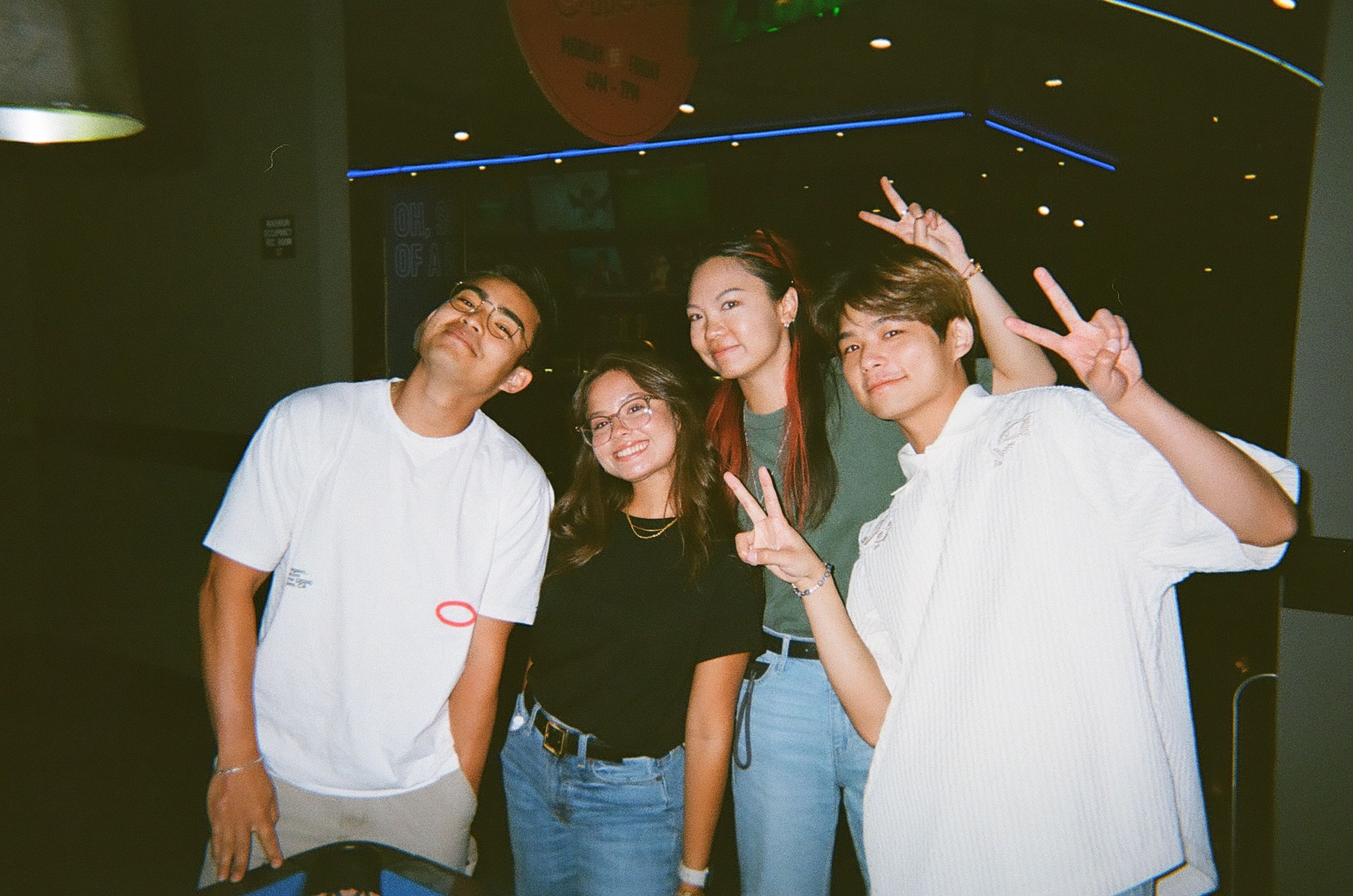 A group of young TikTok interns throwing up peace signs.