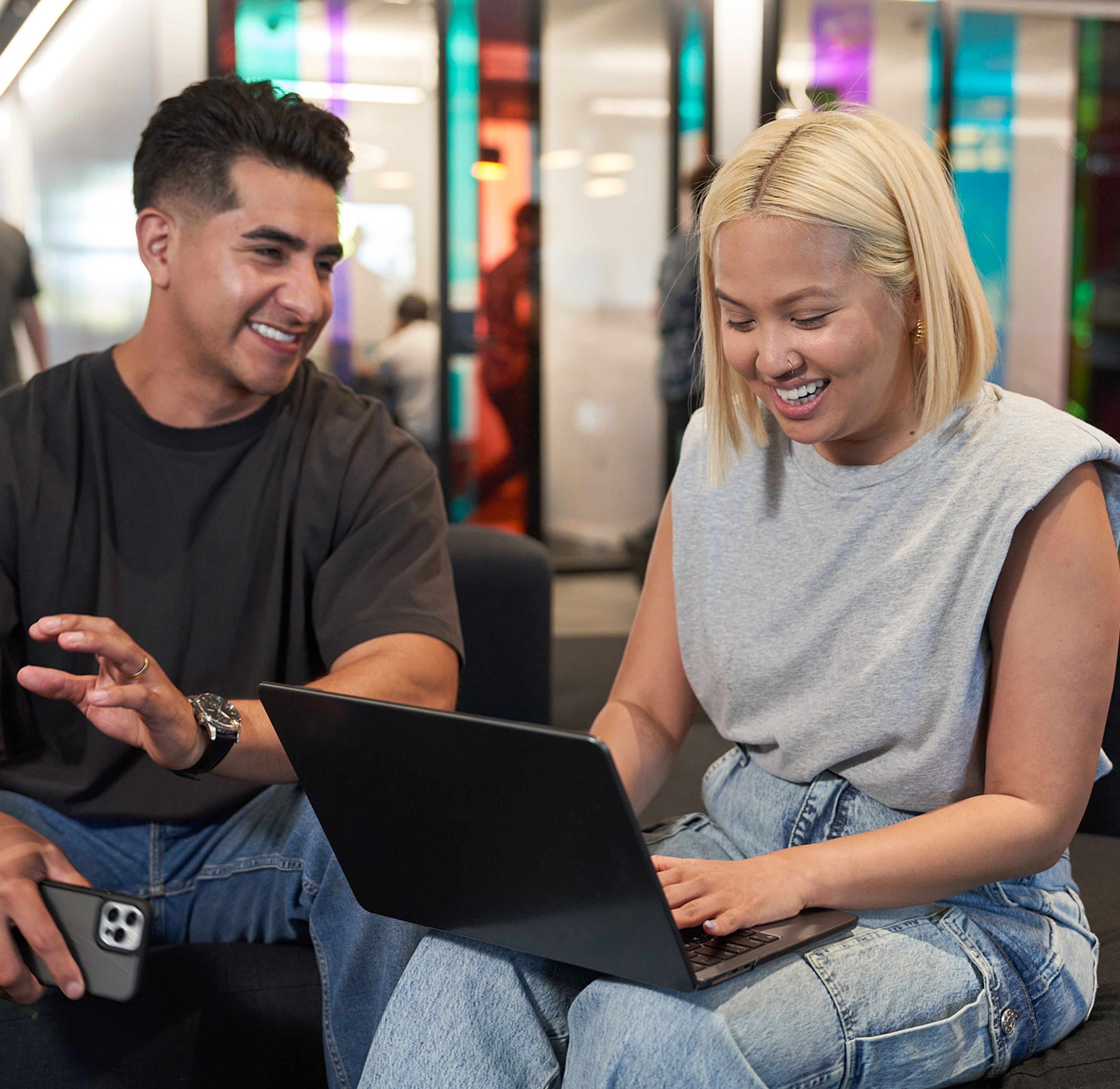  Two ByteDance employees from an office in the Americas work together at a laptop.