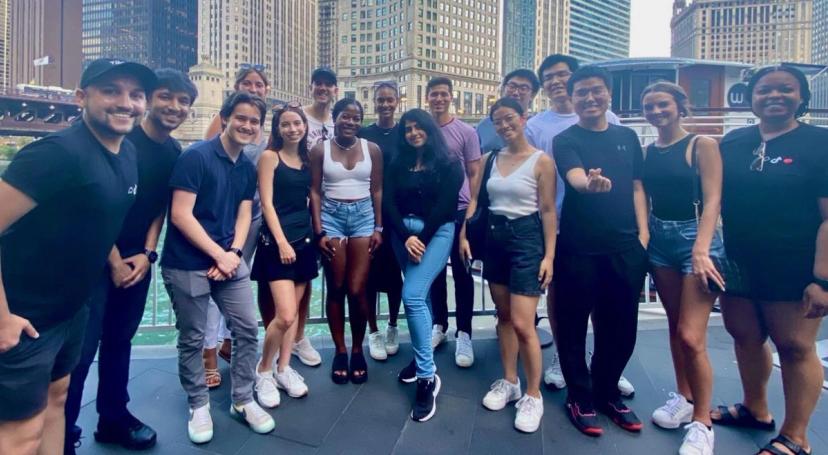 A diverse group of TikTok Graduate Students in a downtown setting pose for a picture.