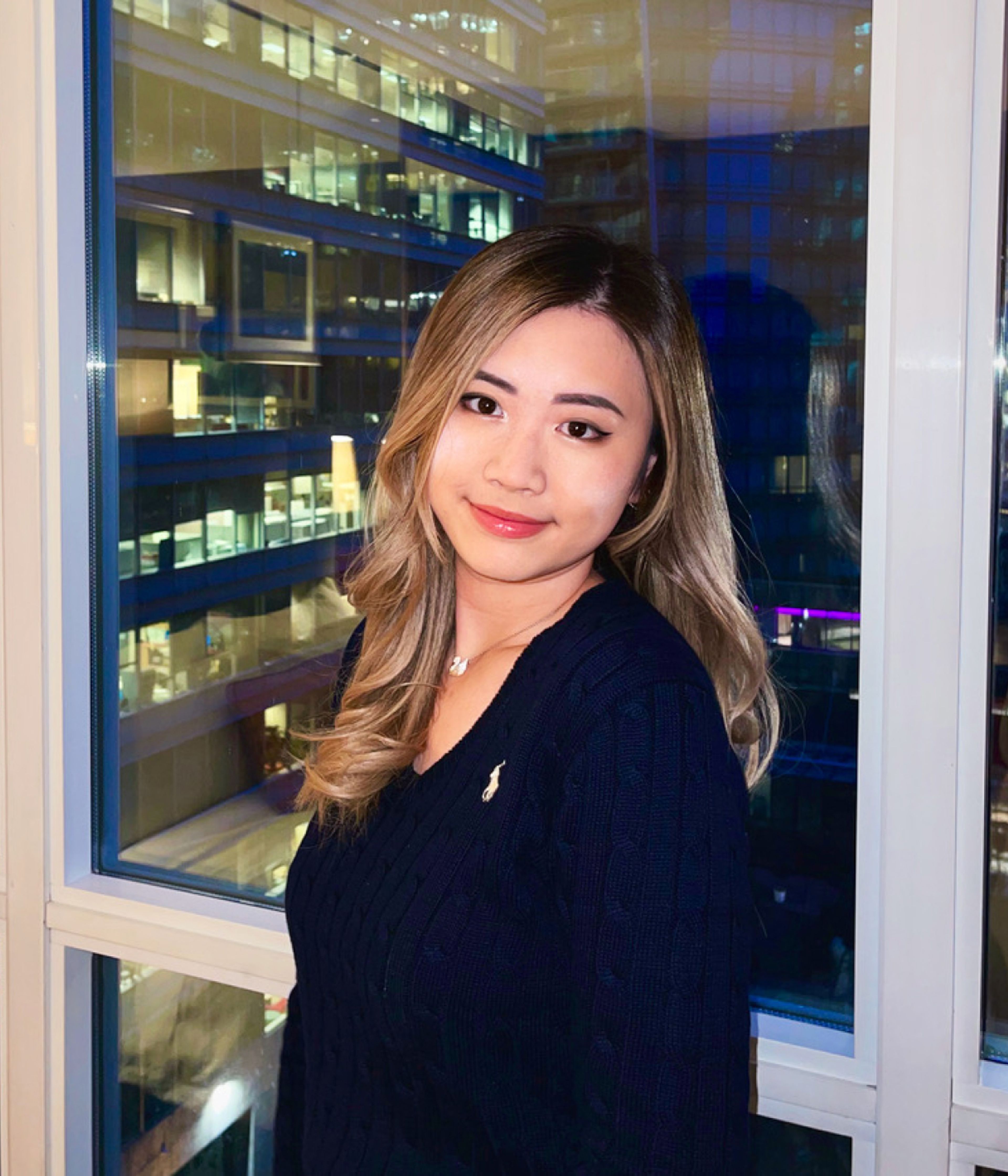 Sarah Wu, an iOS Developer Intern at TikTok, poses for a picture as she stands in front of an office window