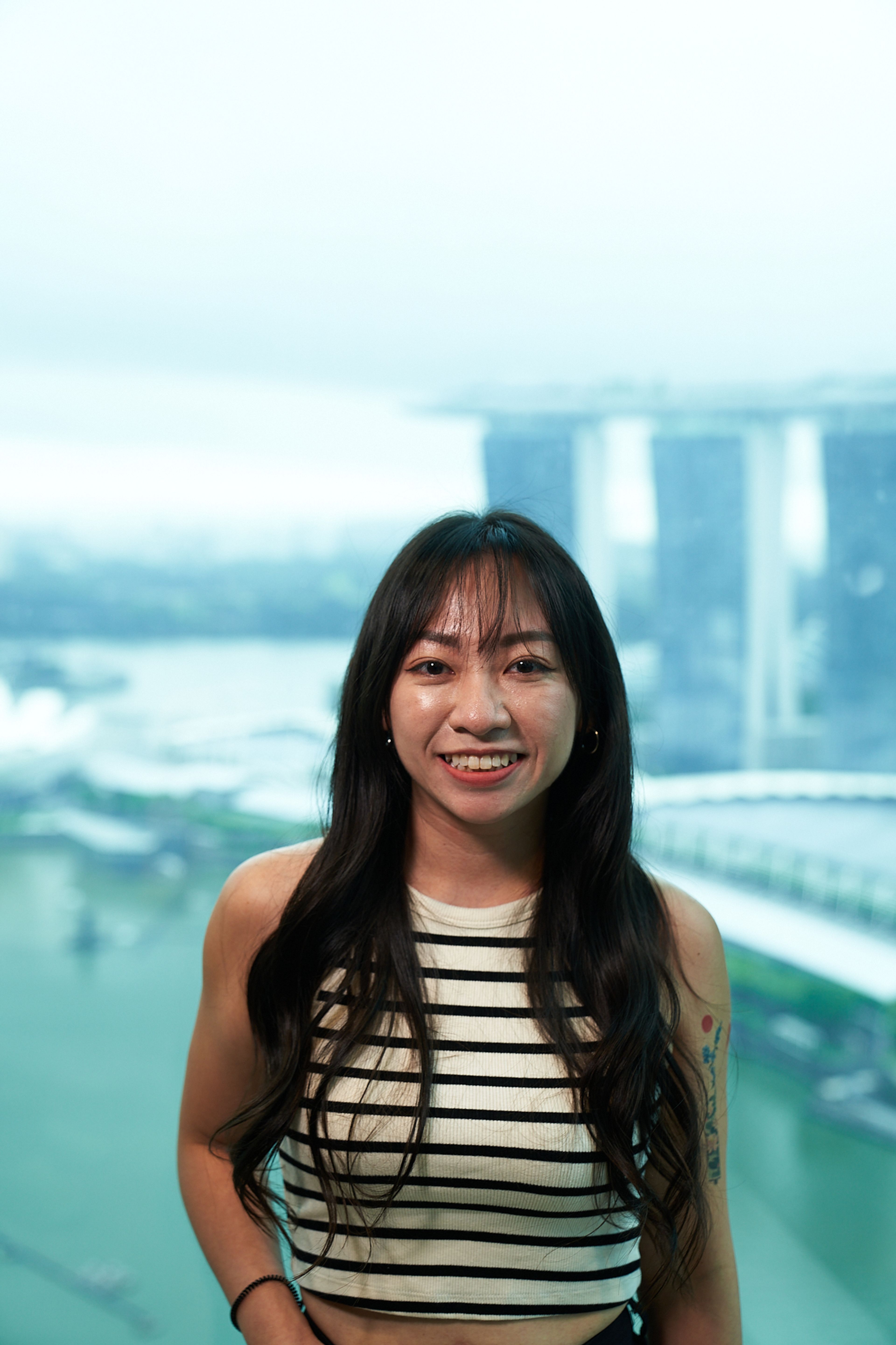 A young female ByteDance employee smiles at the camera.