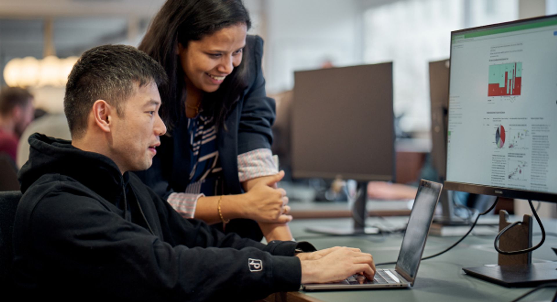 Two ByteDance Summer Undergraduate Interns work together at a computer.