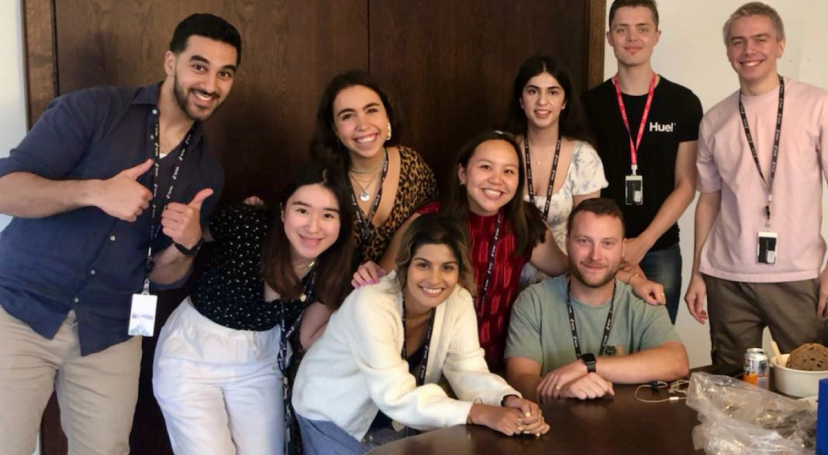 A group of TikTok Summer Undergraduate students smile and give thumbs up as they pose for a picture together.