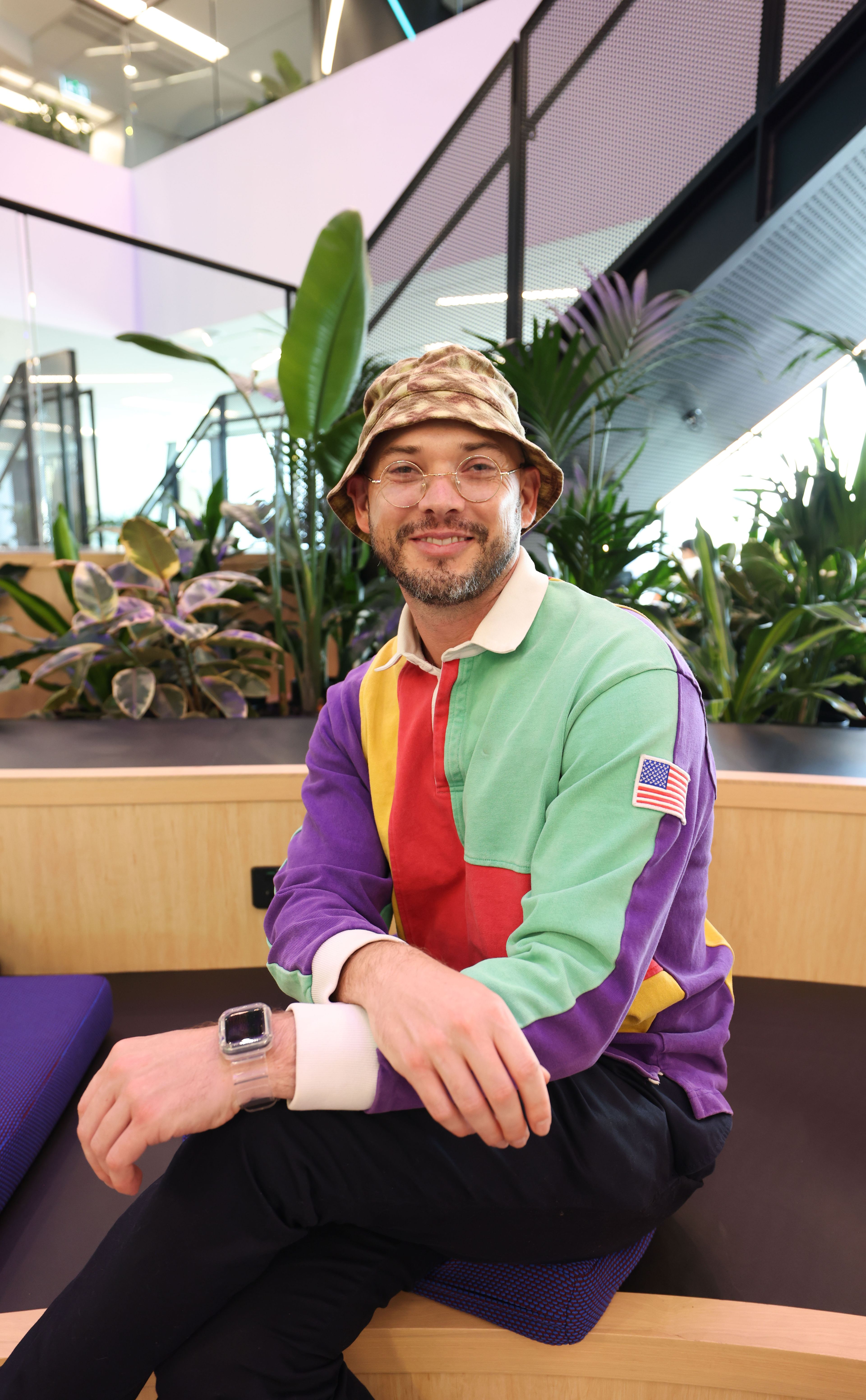 TikTok employee in the Sydney office sitting and posing for hte camera.