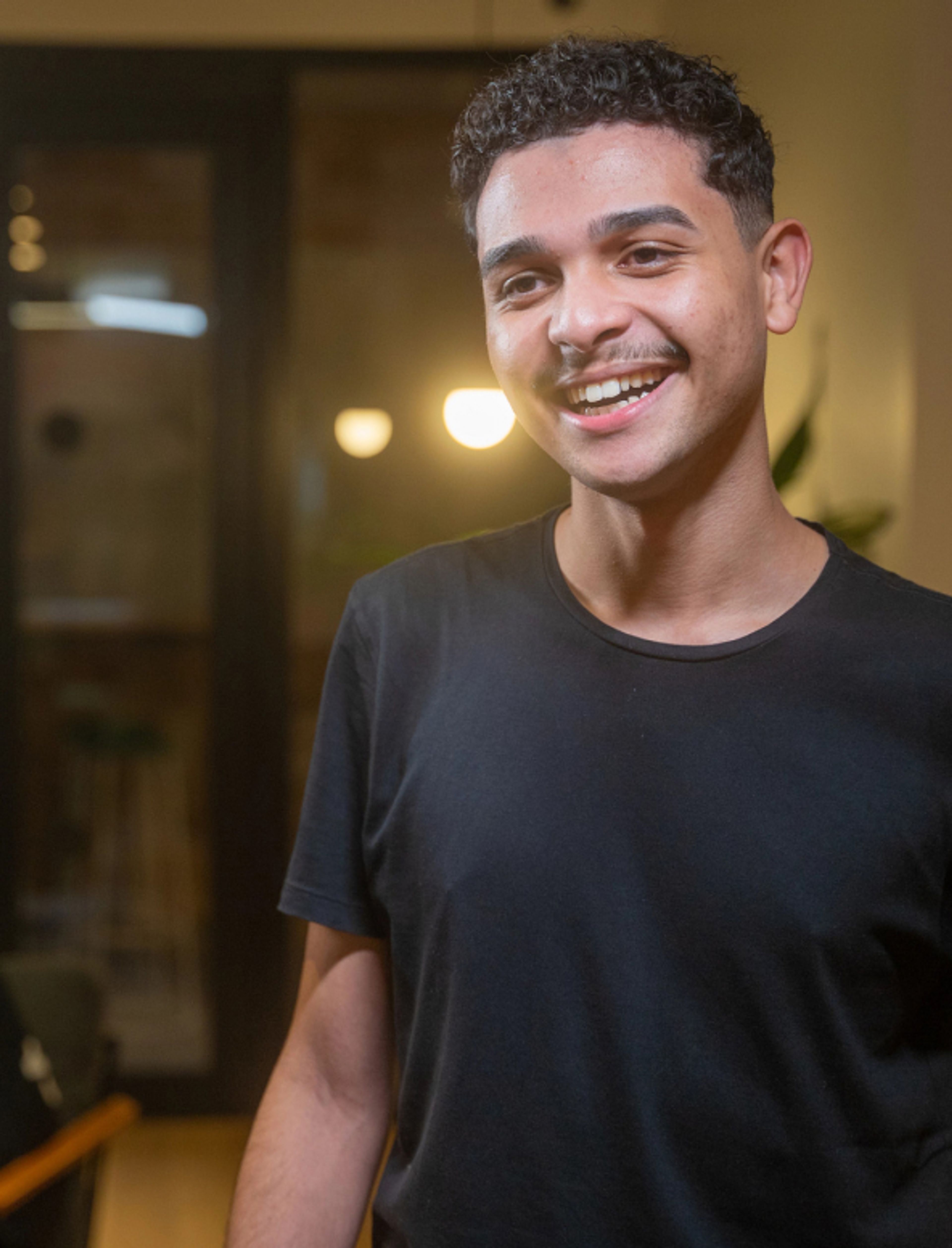 A young male ByteDance employee smiling.