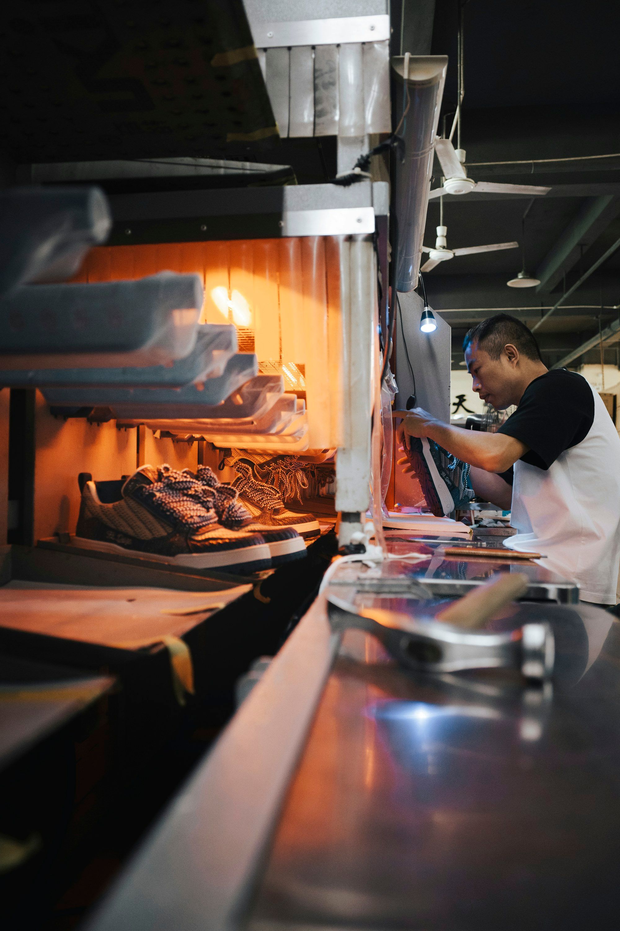 A worker at a shoe factory assembly line in Dongguan, China