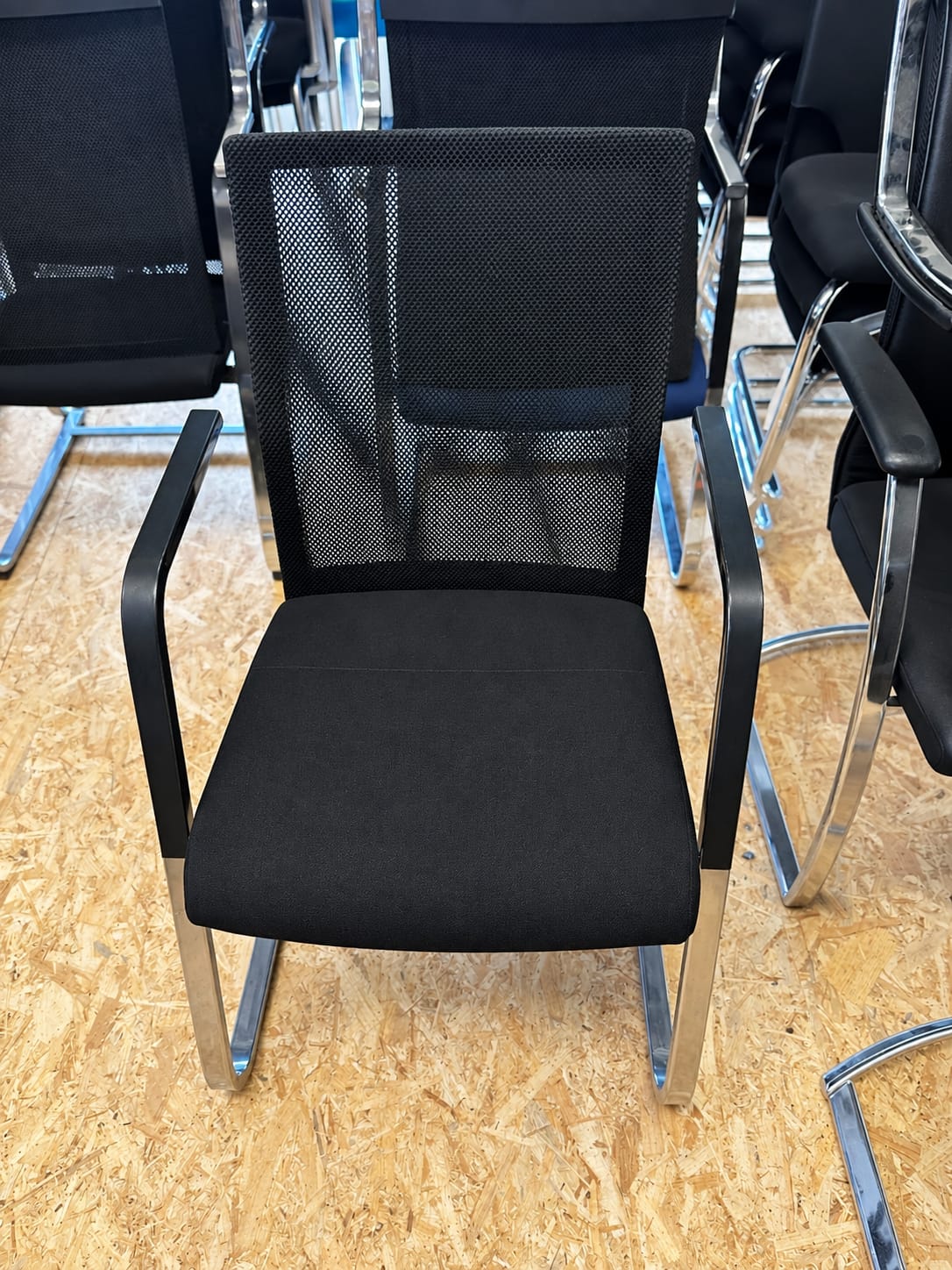 Chaise d’accueil noire avec dossier résille et accoudoirs - vue 3