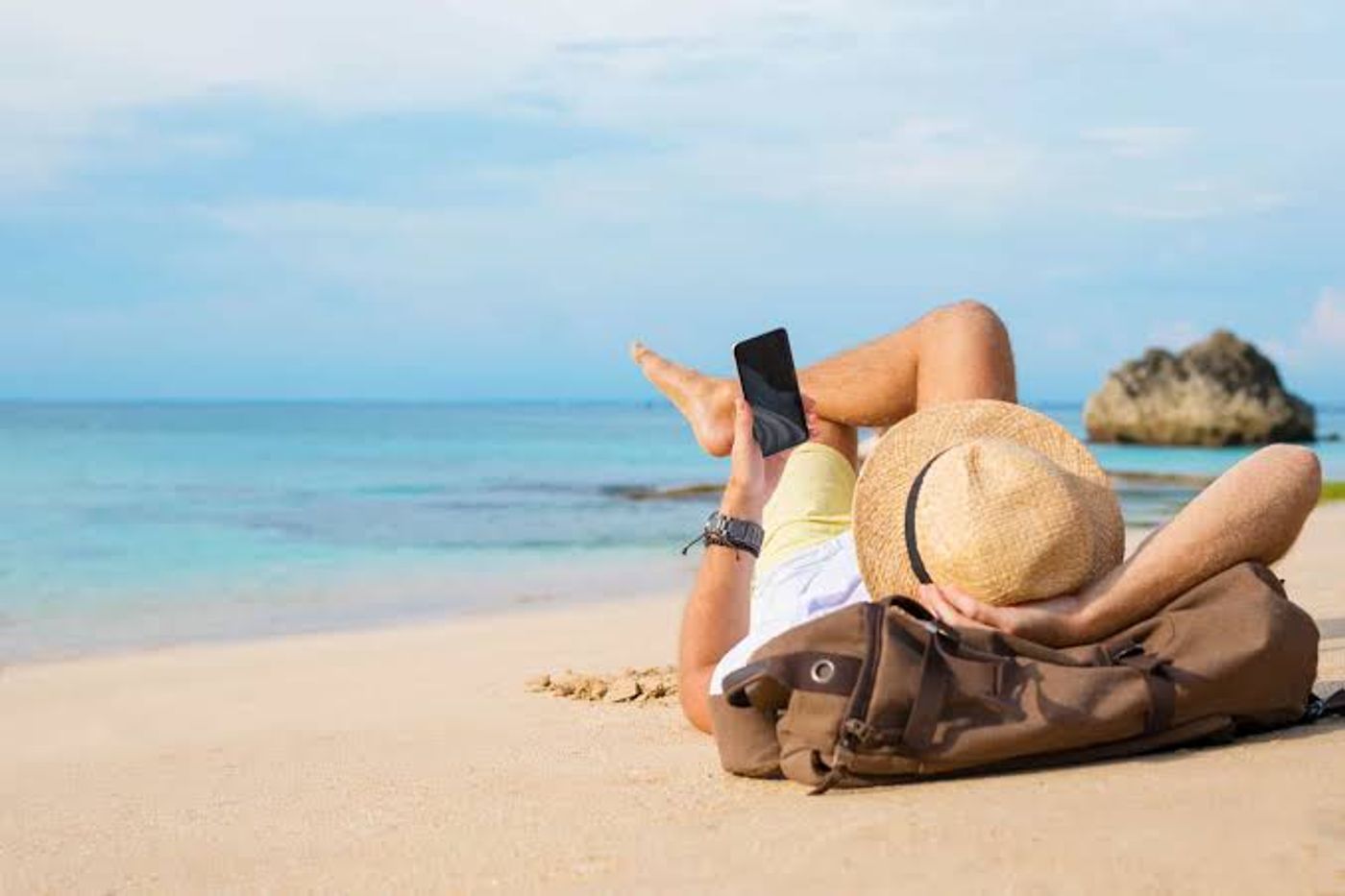 Traveler planning a trip on the beach