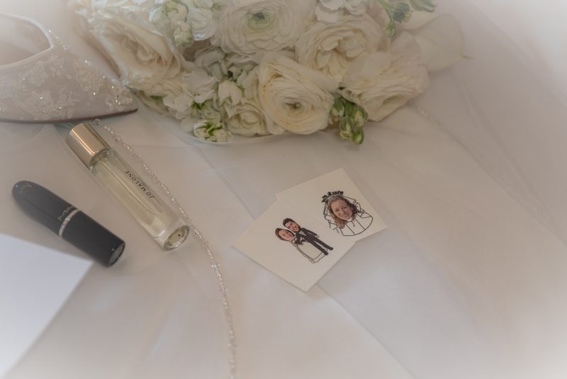 A serene moment captures Carmela's wedding preparations, featuring a bouquet of white ranunculus and personal items.