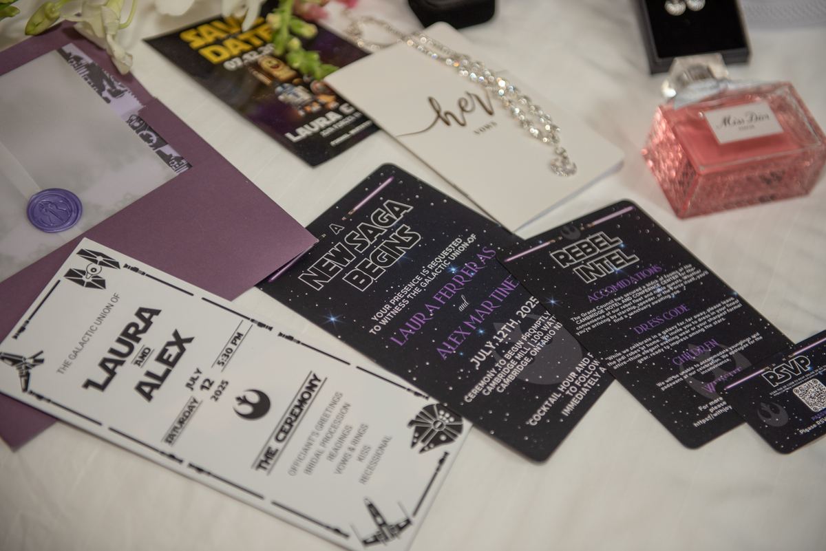 Star Wars wedding invitations and accessories, including a pink glitter perfume bottle and sparkling necklace.