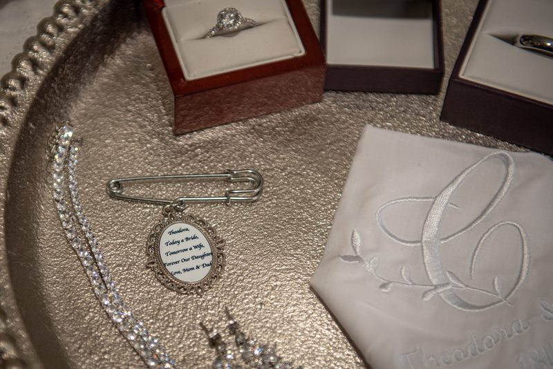 Wedding trousseau items including ring, safety pin, necklace, and handkerchief create an elegant scene.