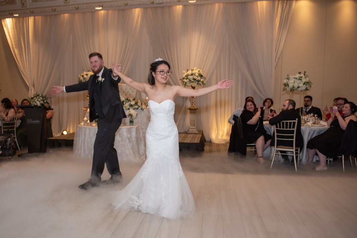 Jomelle and Matthew joyfully dancing on a fog-covered dance floor at their wedding reception in Vaughan.