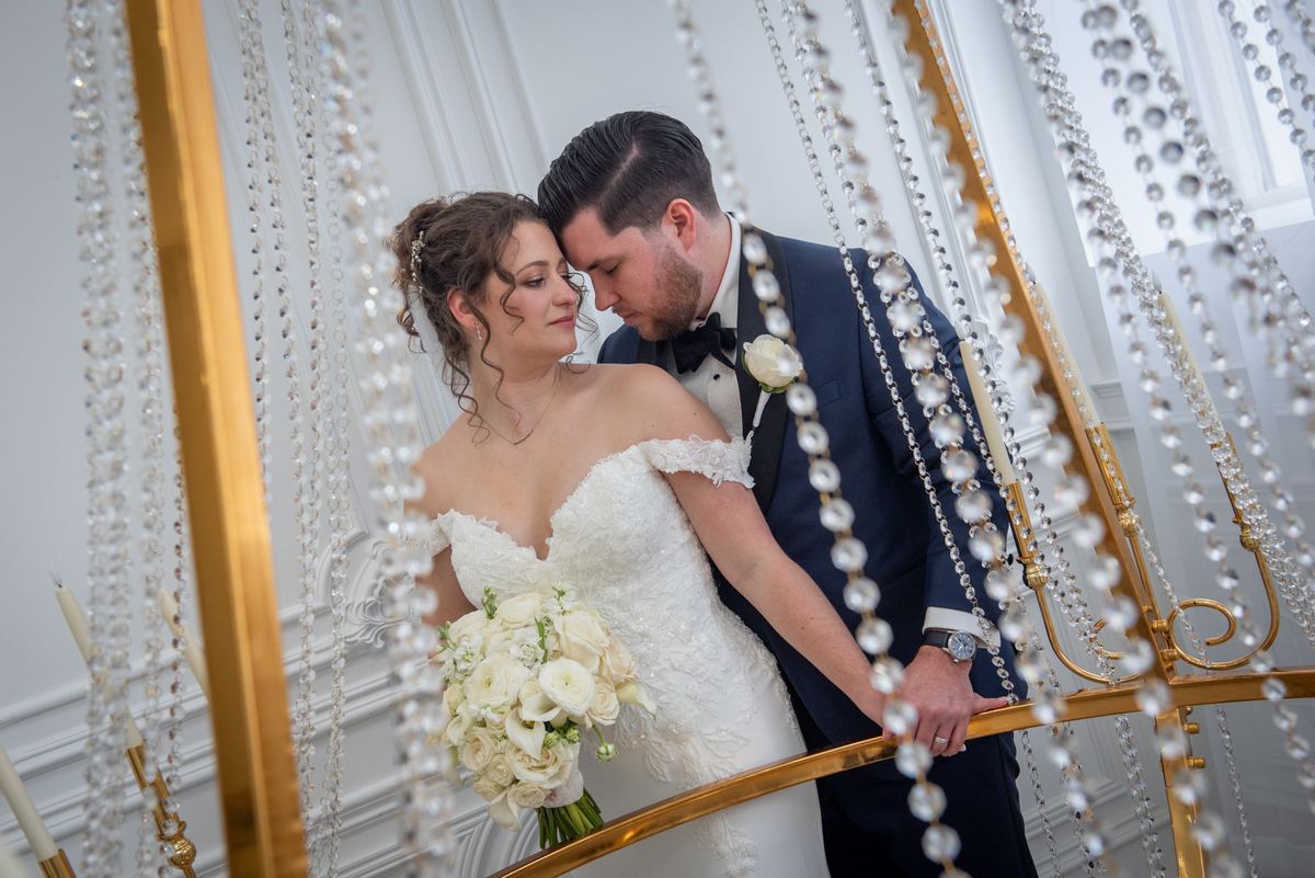 Carmela and James share an intimate moment, their foreheads touching as they gaze at each other with quiet emotion.