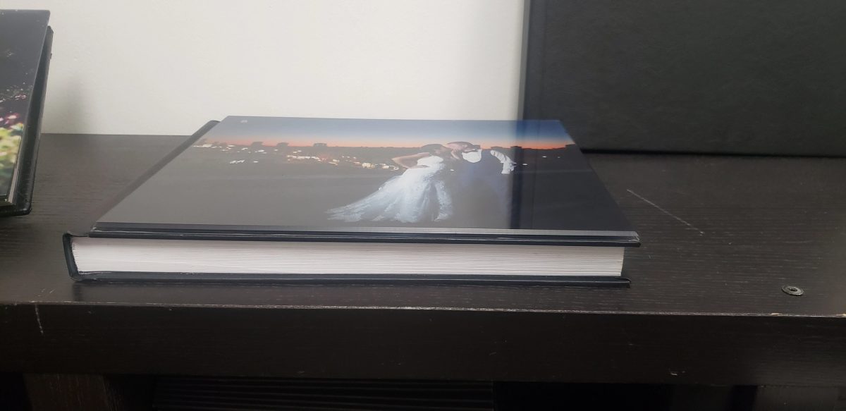 The side of a layflat wedding album, showing the thick block of matte pages