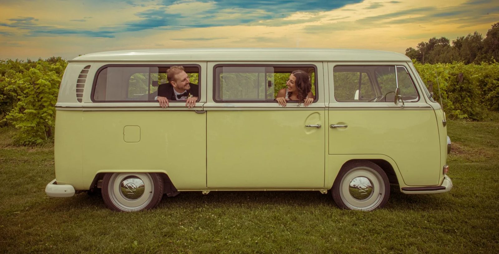 A couple in a quiet moment after the ceremony in a vw van from the 60s