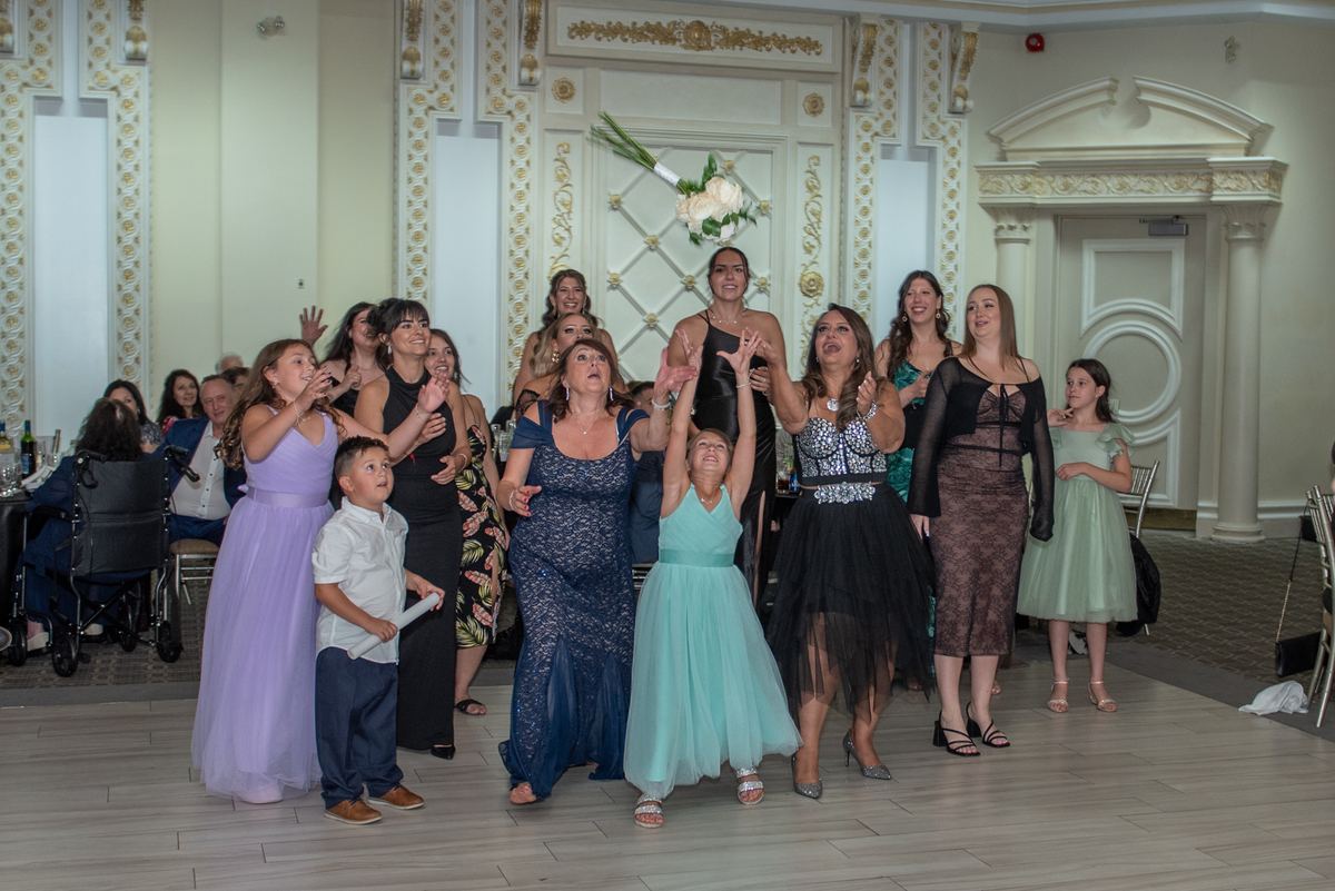 Formal guests at Erica and Francesco's wedding reception in Vaughan, raising arms and smiling on the dance floor.
