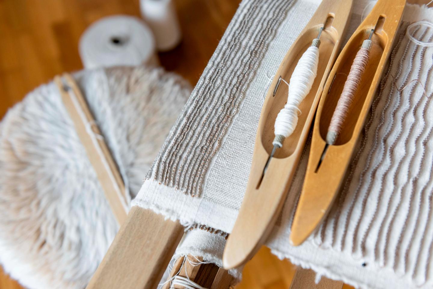 Pleated textile and weaving tools in the workshop
