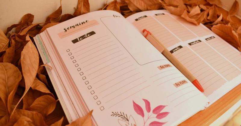 Open study planner with handwritten notes and pen