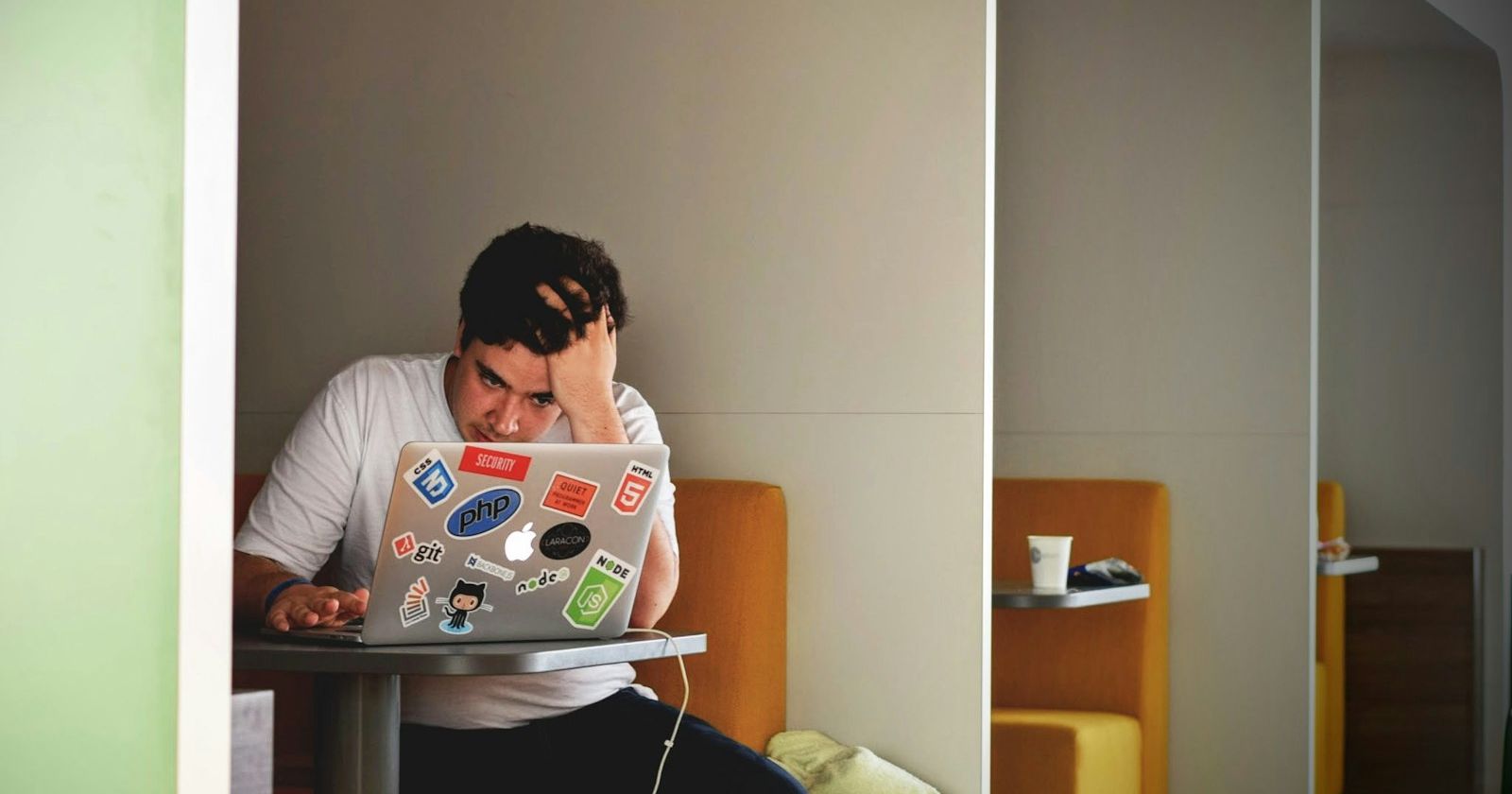 Person concentrating at a laptop while studying