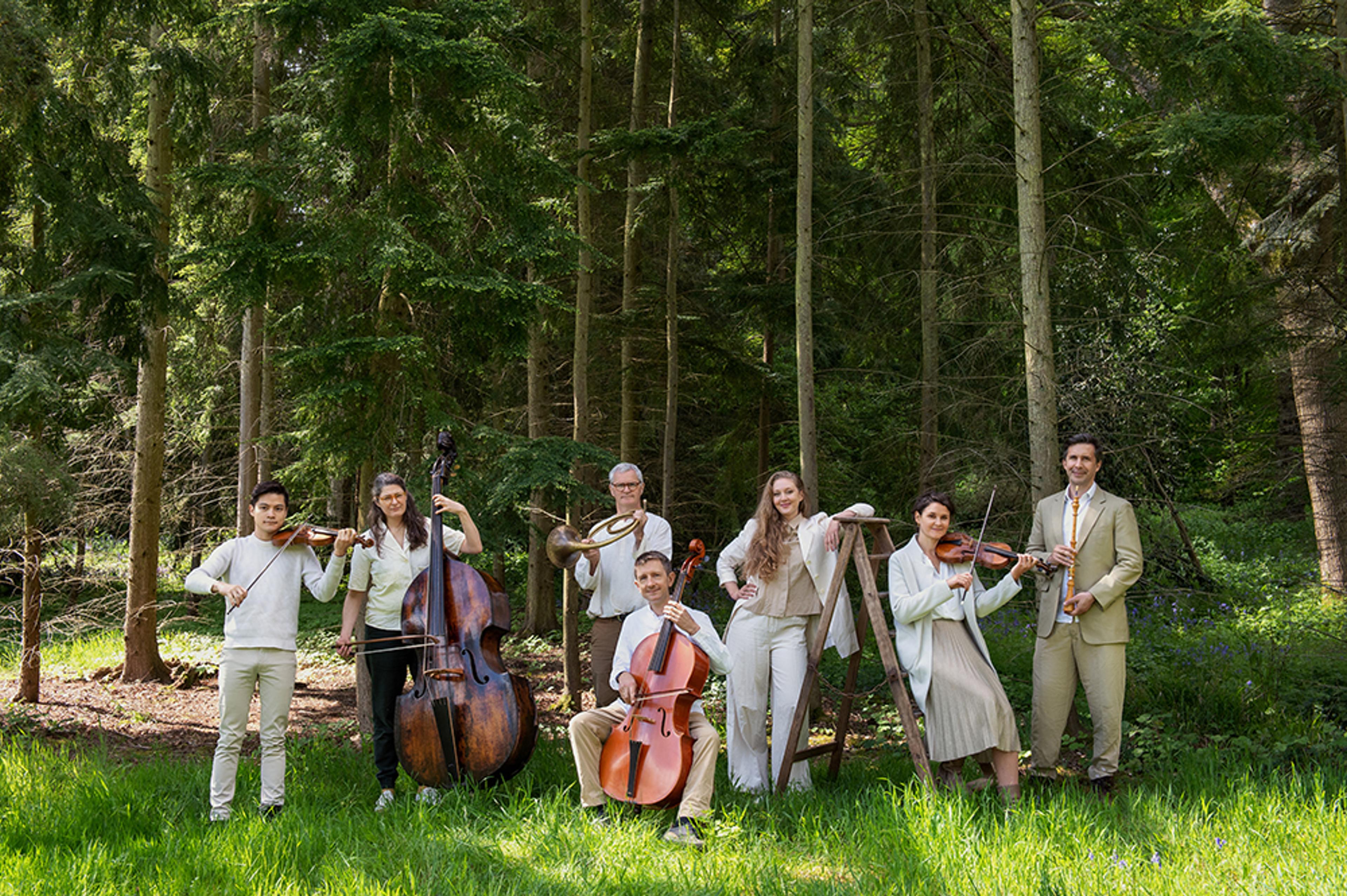 Members of the OAE posing with instruments in nature 