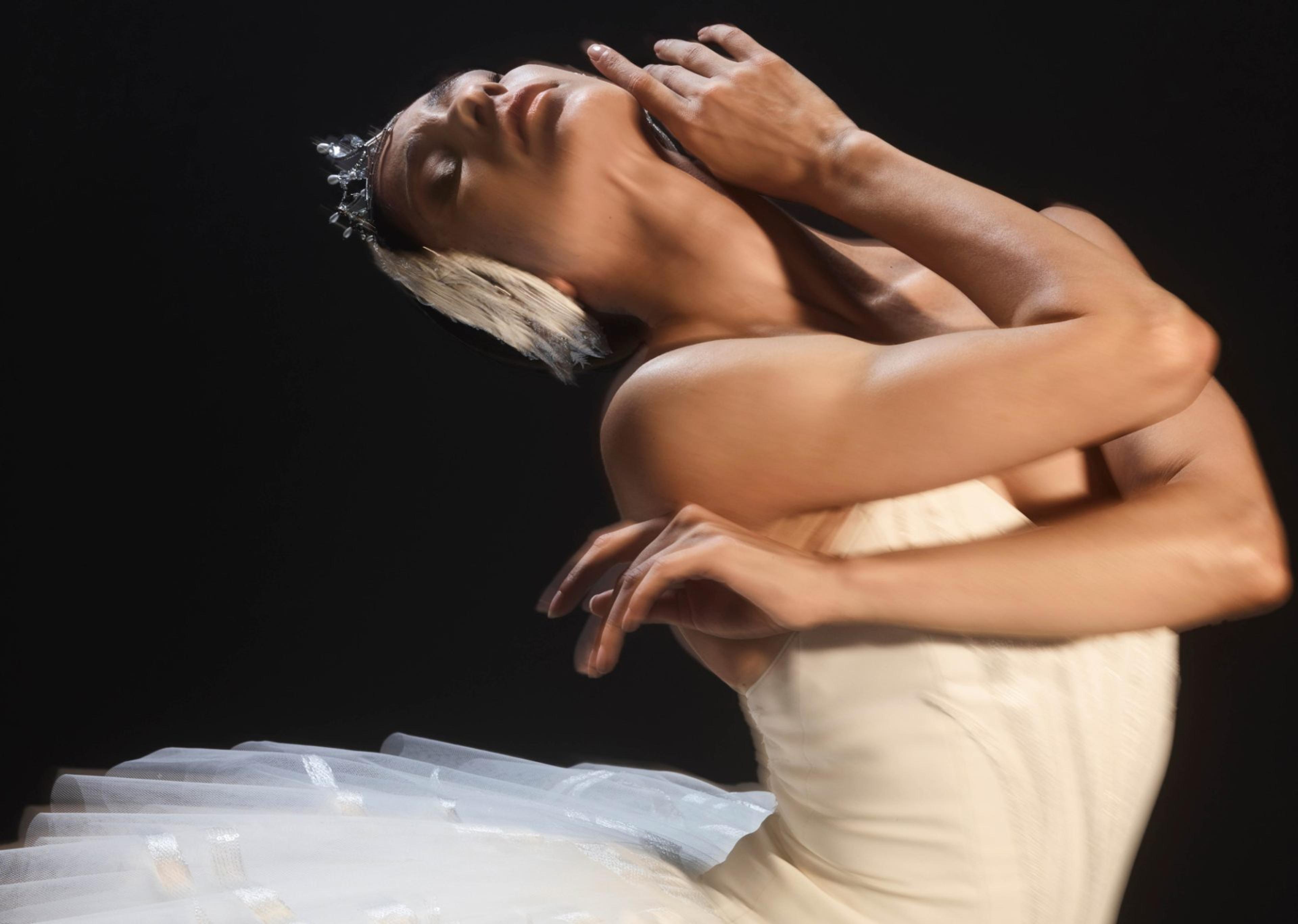 Ballerina in dramatic pose in a production of Swan Lake