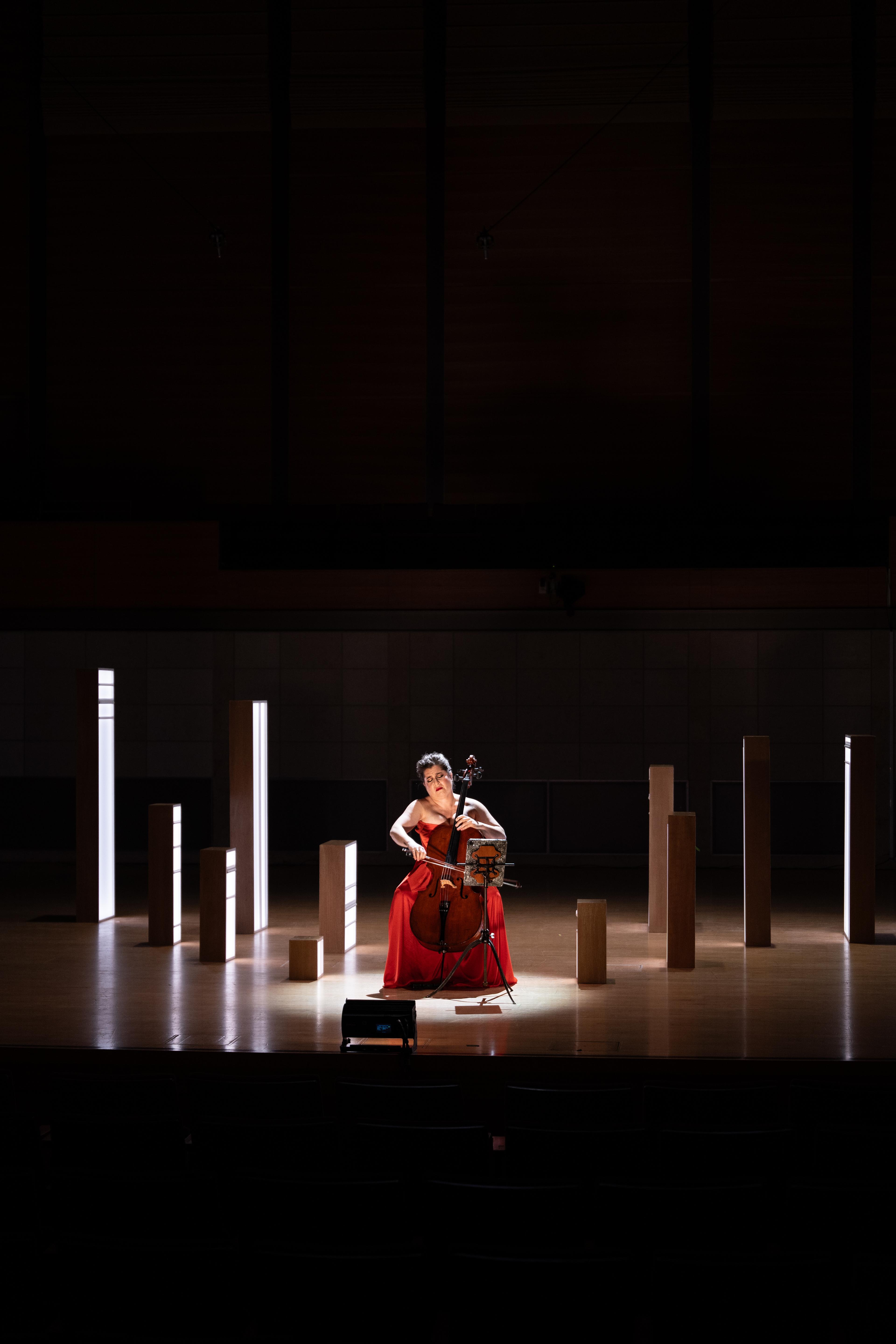 Cellist Alisa Weilerstein performing amidst light boxes