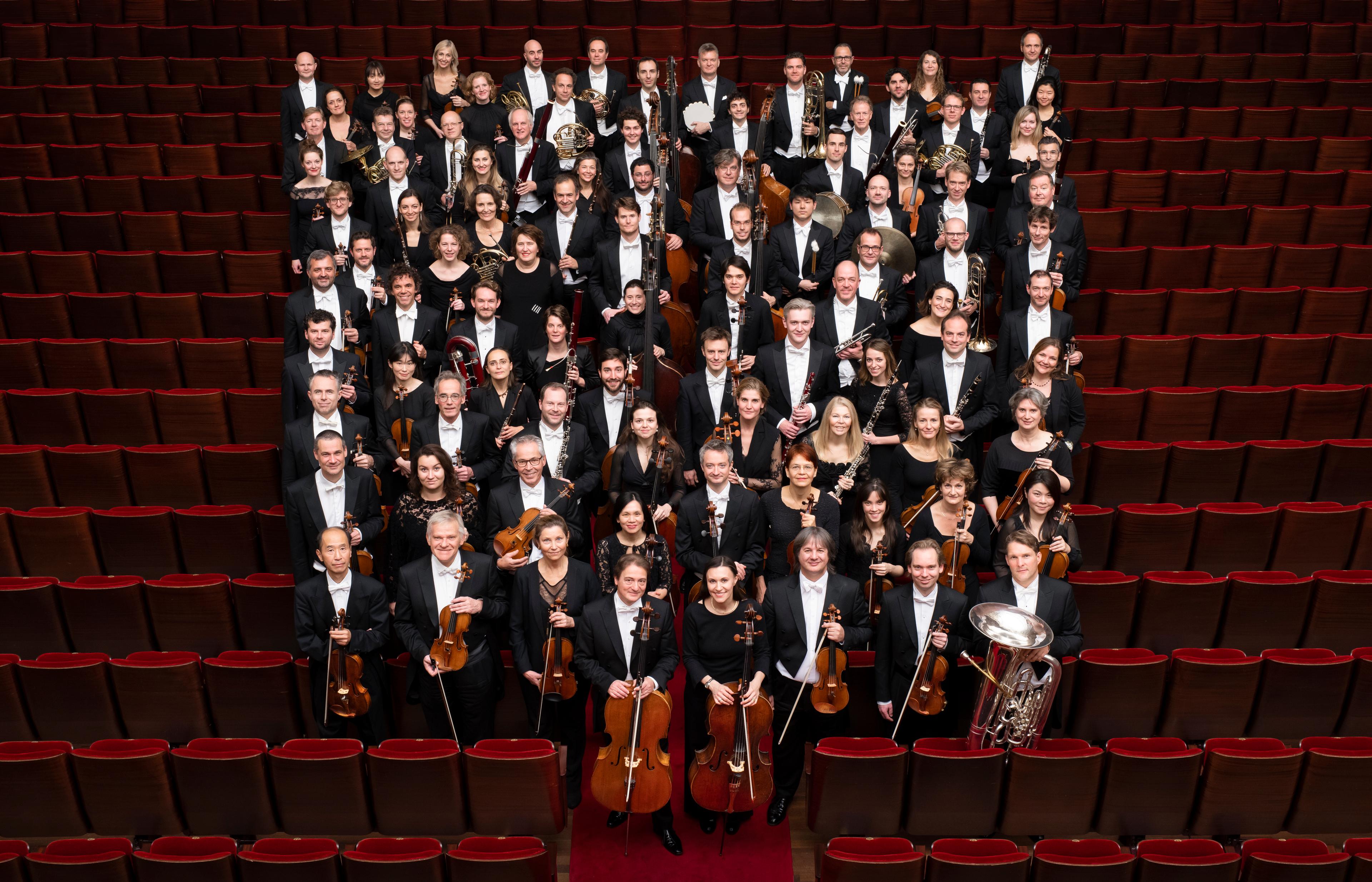 Royal Concertgebouw Orchestra standing together with their instruments
