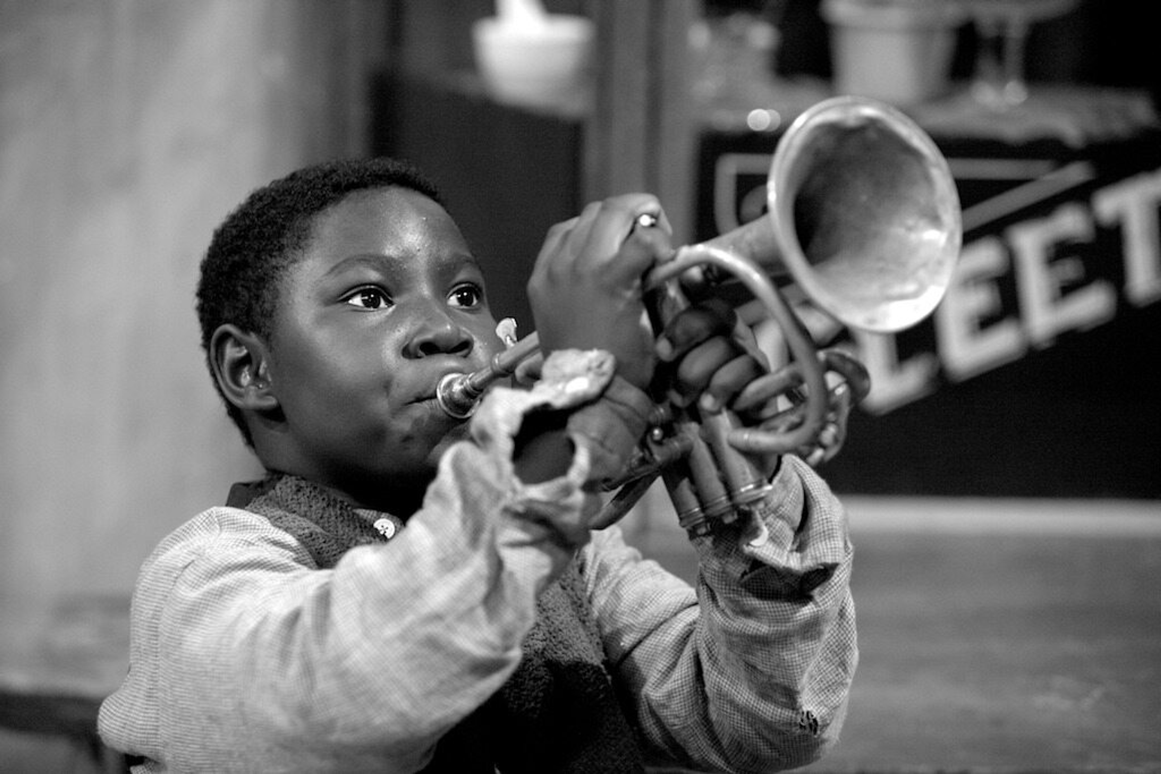 Louis Armstrong as a young boy playing the trumpet