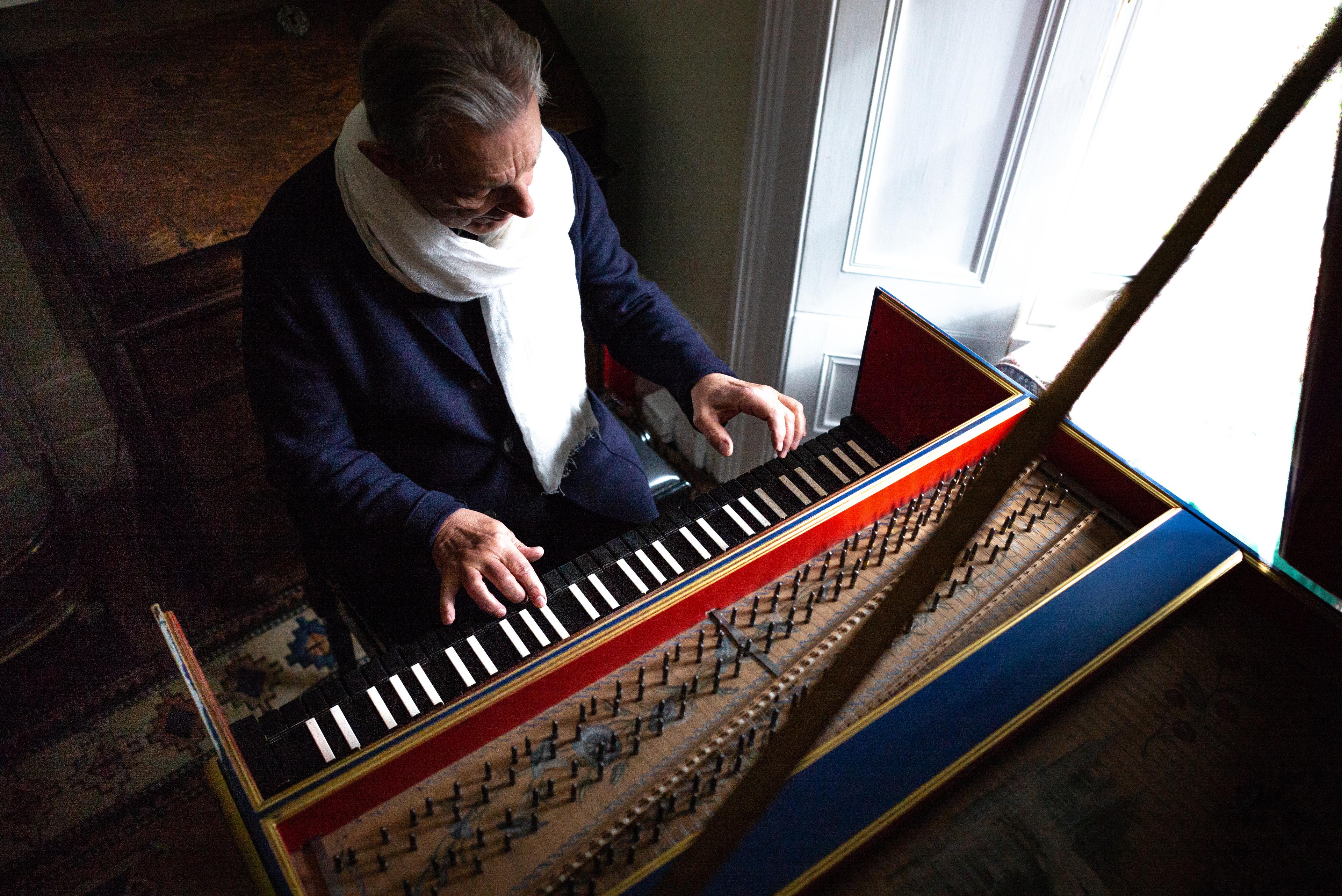 picture of Trevor Pinnock sat at his harpsichord taken from above
