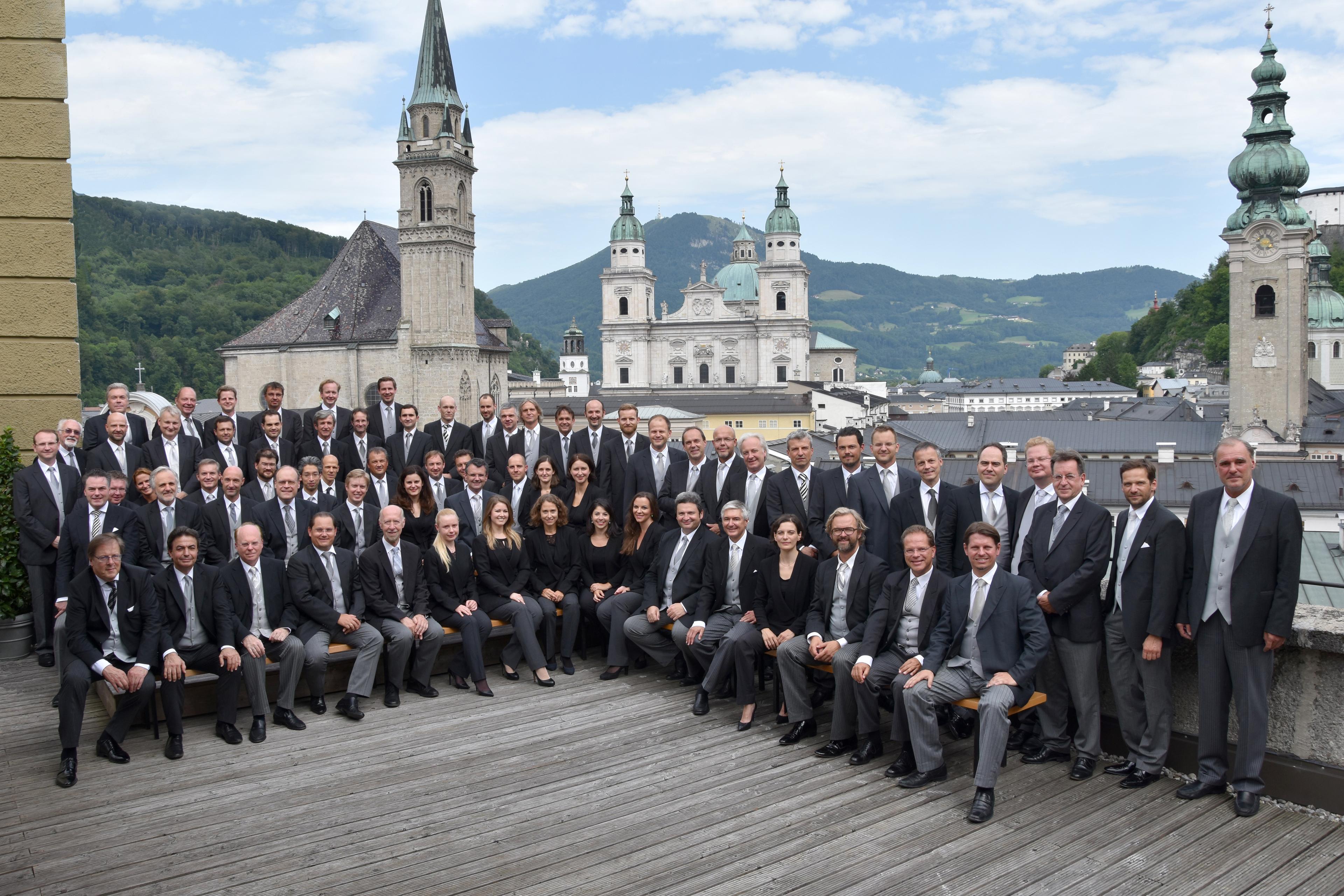 Musicians of the Wiener Philharmoniker gathered outdoors in Salzburg