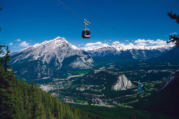 A gondola above mountain scenery.