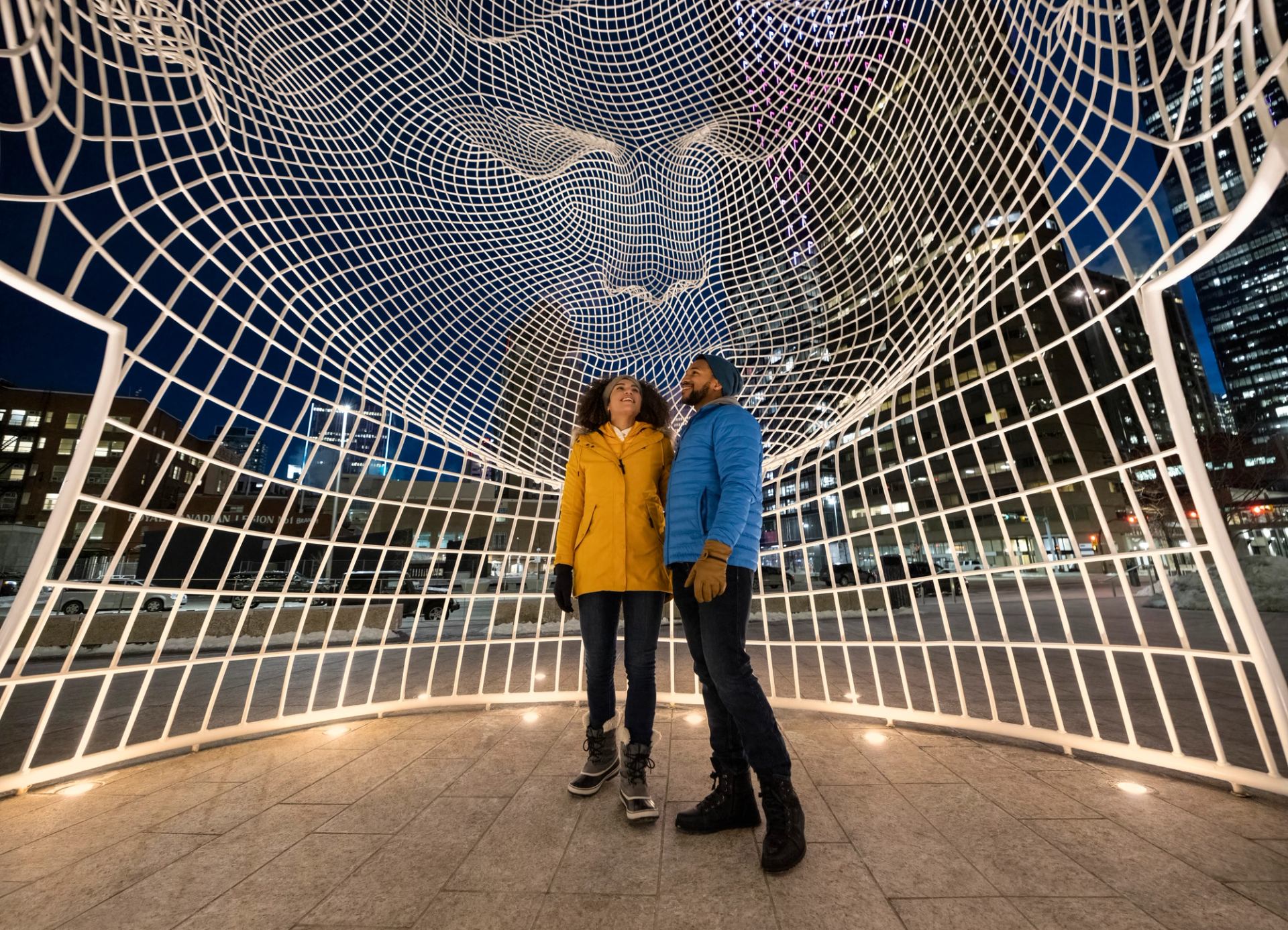 A couple inside the Wonderland sculpture in downtown Calgary.
