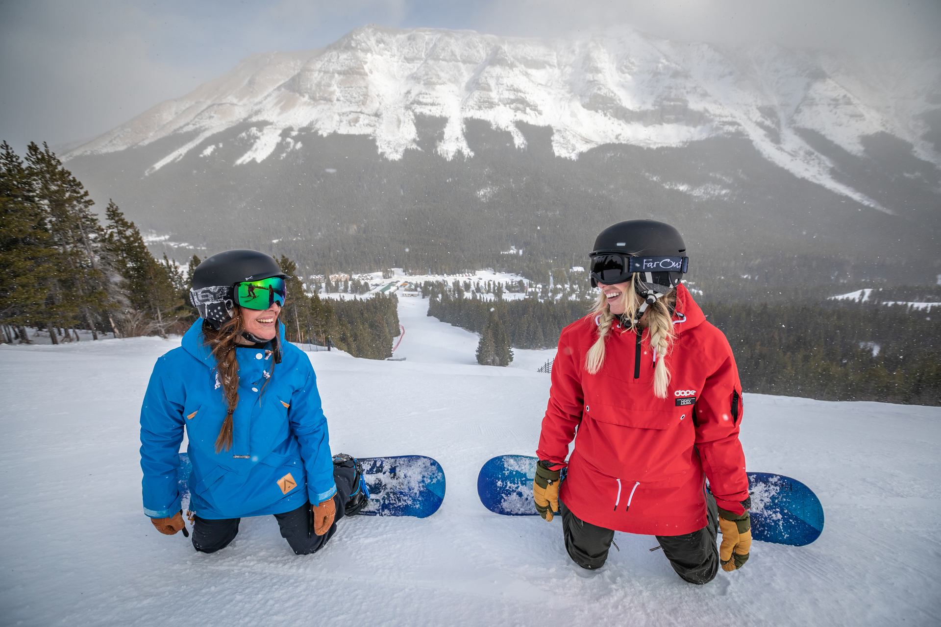 Two women taking a break from snowboarding at Castle Mountain Resort