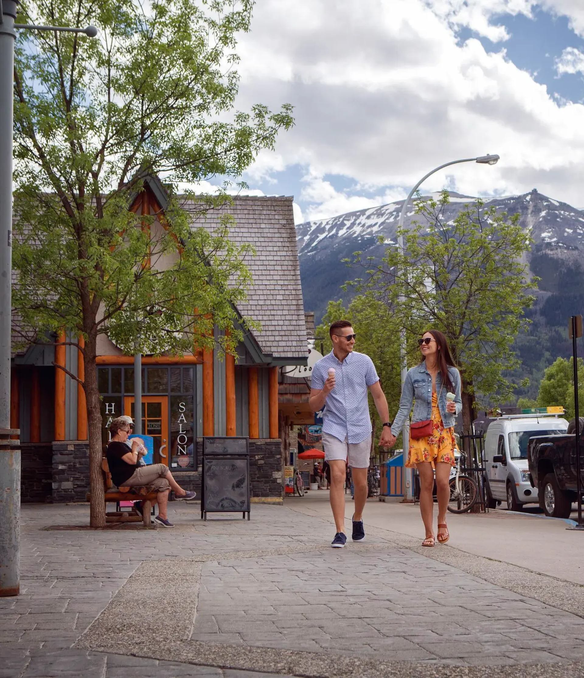 Couple strolling down a charming mountain town eating ice cream