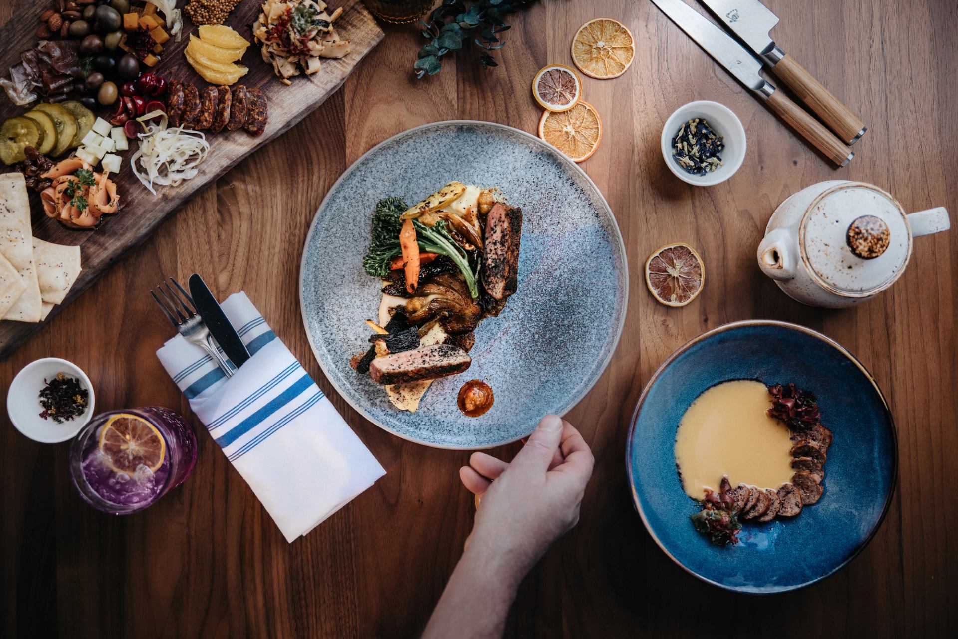 A closeup of a plate of food and other dishes on a table at Aalto in Jasper, Alberta.