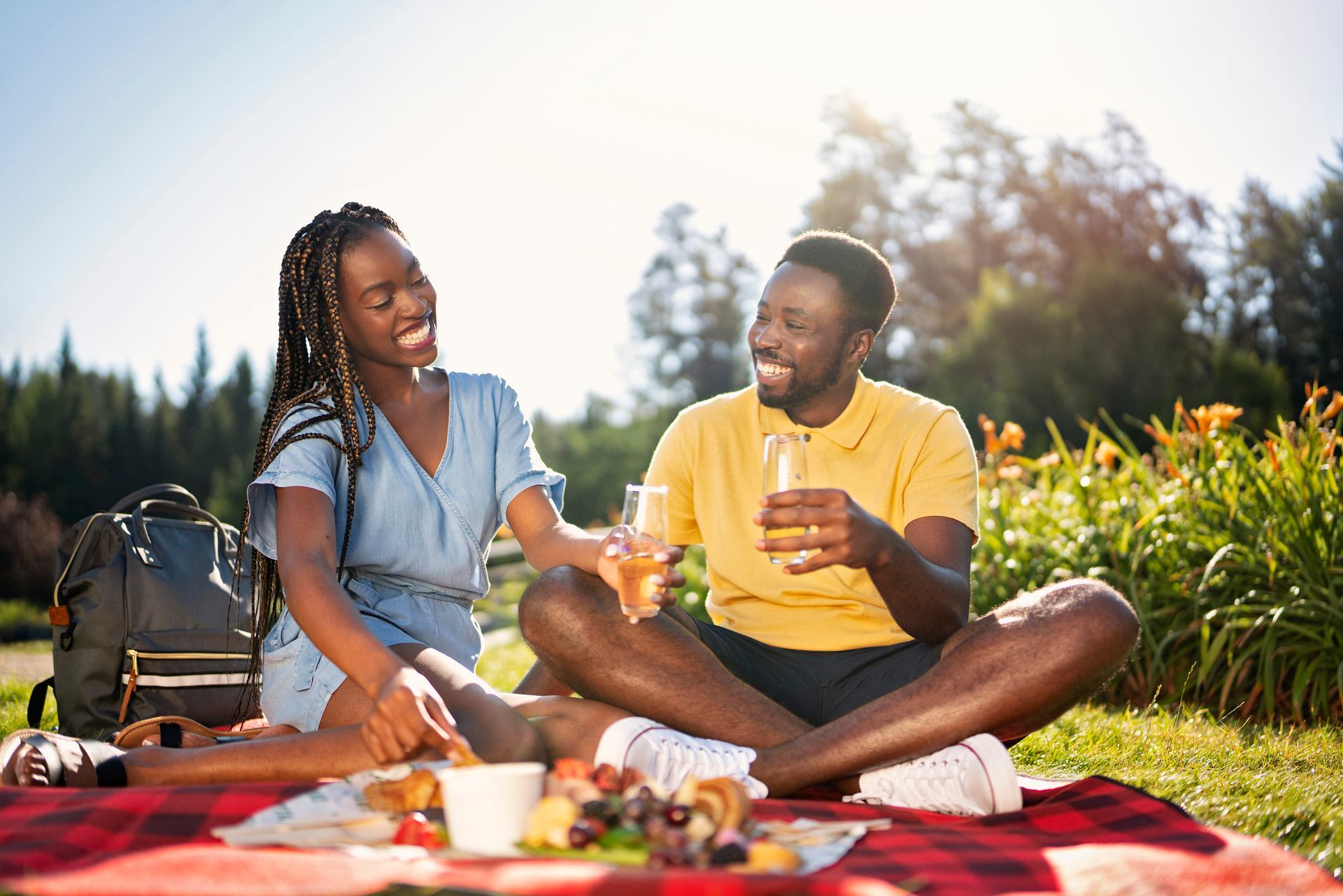 Couple have a picnic amid flowers and trees