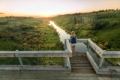 Person looking at the sunset on the Beaver River Trestle near Cold Lake
