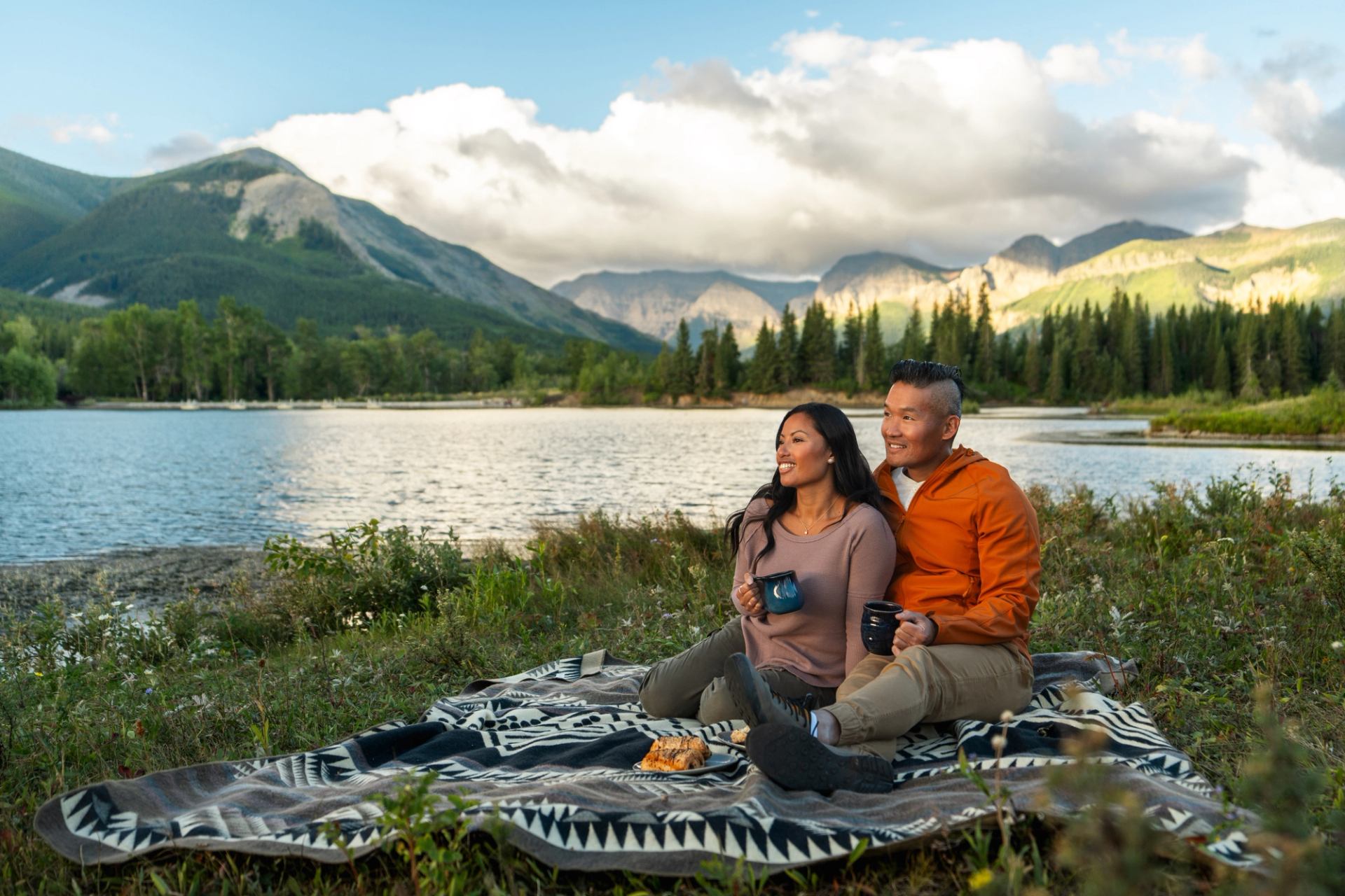 Couple having a picnic in front of a lake in the Southern Rockies