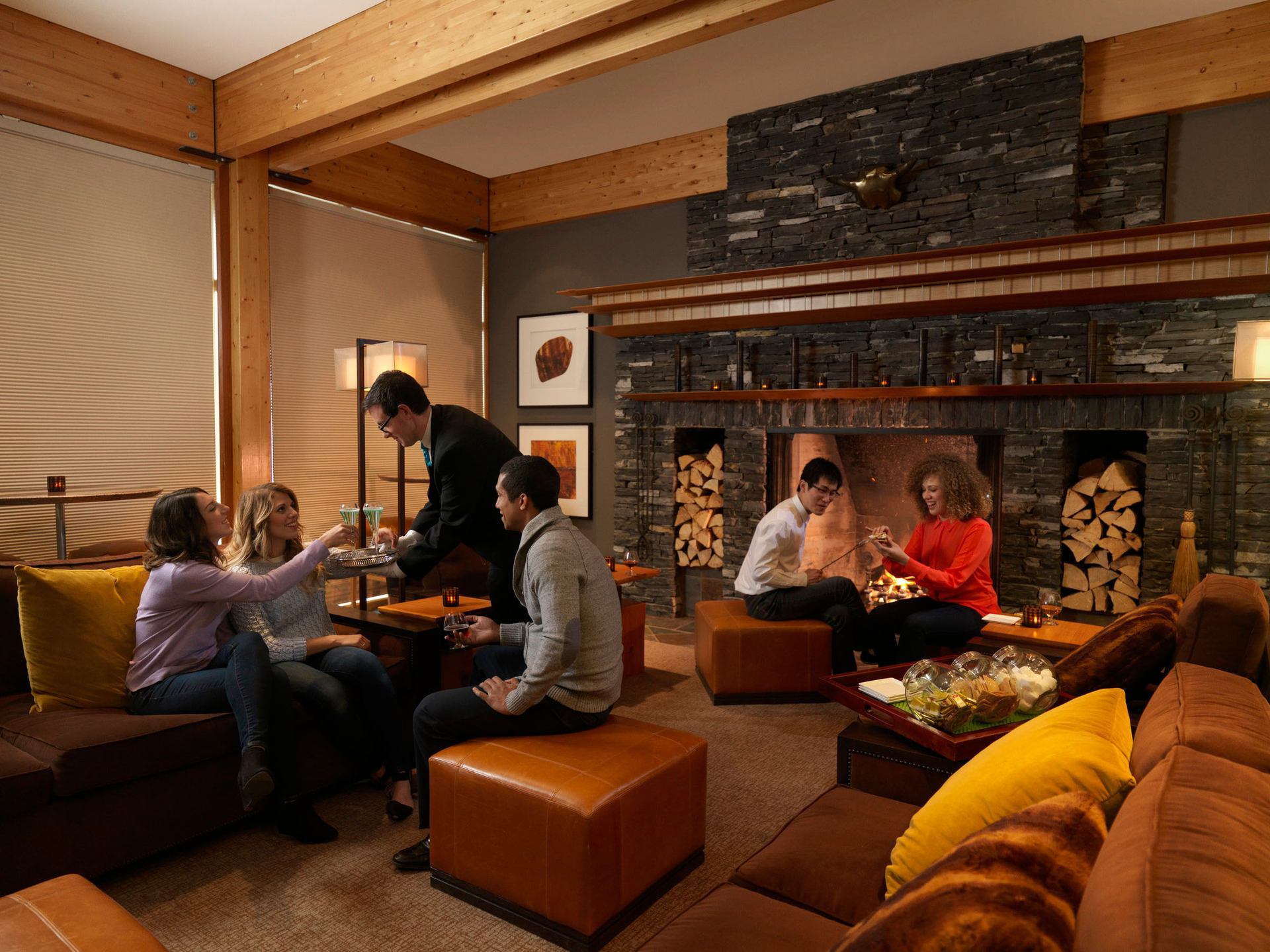 Friends enjoying drinks and smores at the Azuridge Hotel in Priddis.