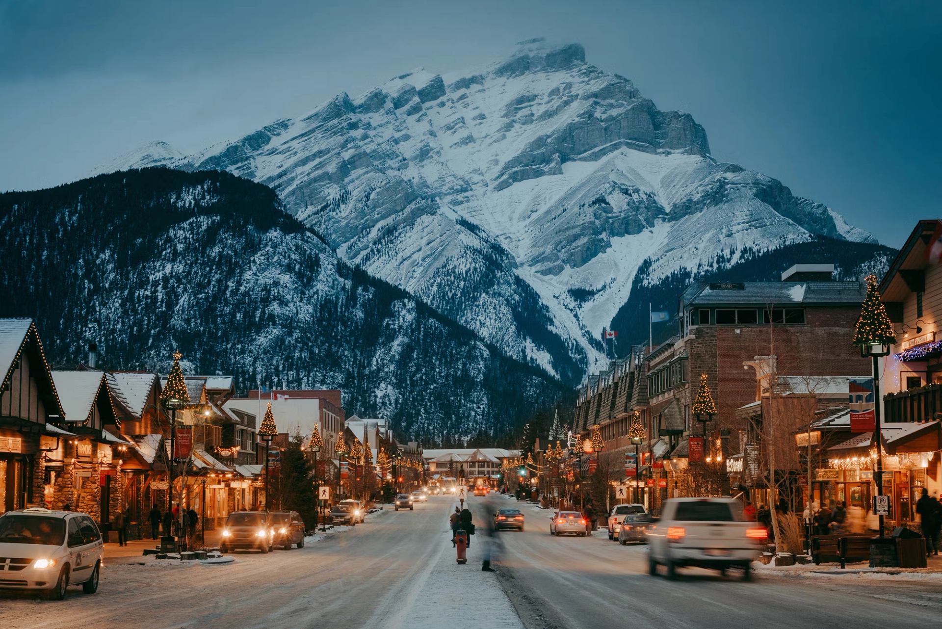 A serene snowy street scene in Banff, showcasing cozy buildings and a blanket of fresh snow.
