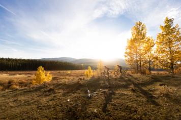 Two people mountain biking in the Foothills during autumn.